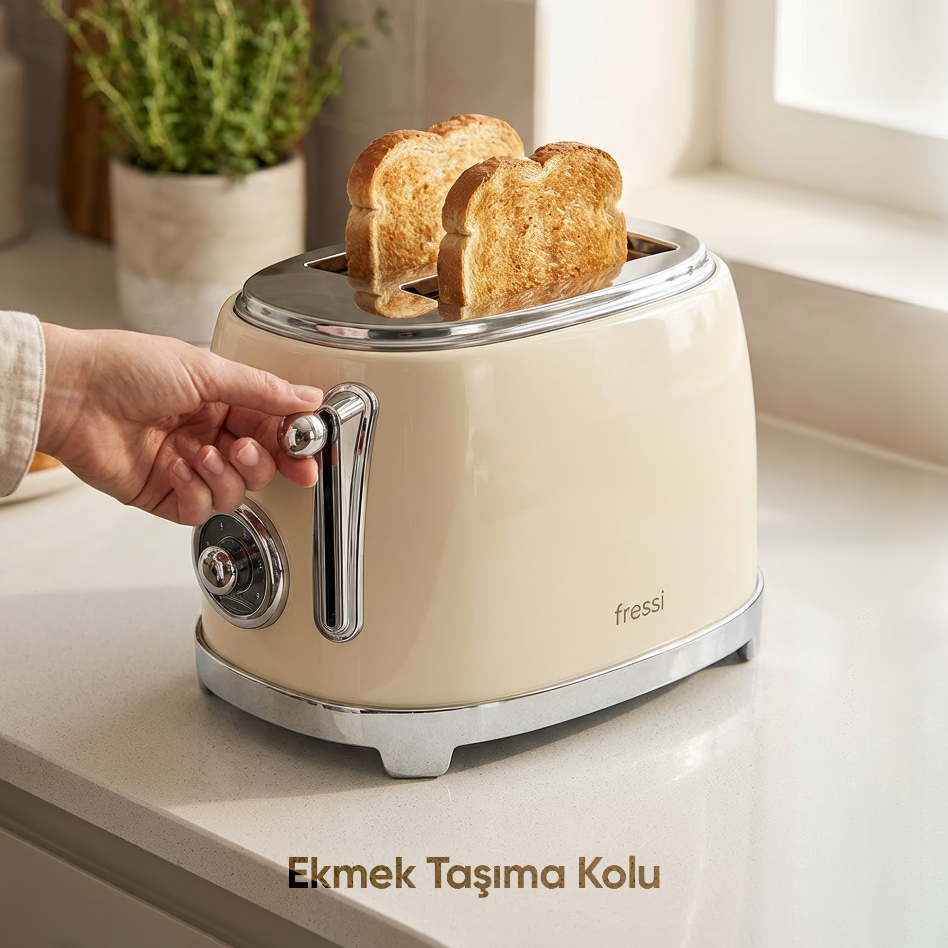 Bir el, içinde iki altın rengi tost bulunan krem rengi bir ekmek kızartma makinesini ayarlıyor.