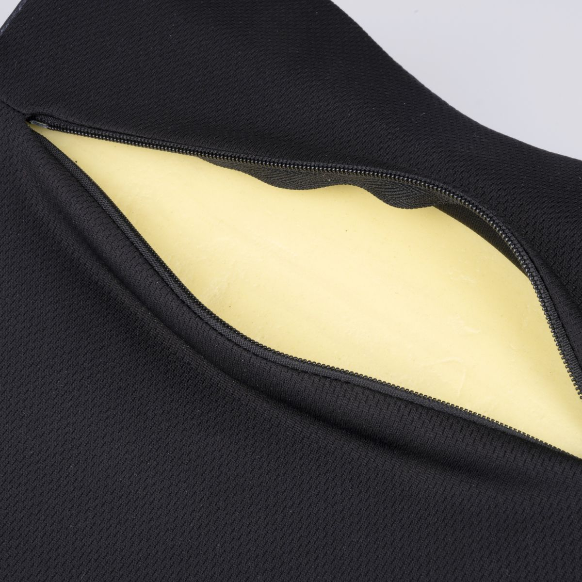 A black cover is partially unzipped, revealing a yellow foam insert.