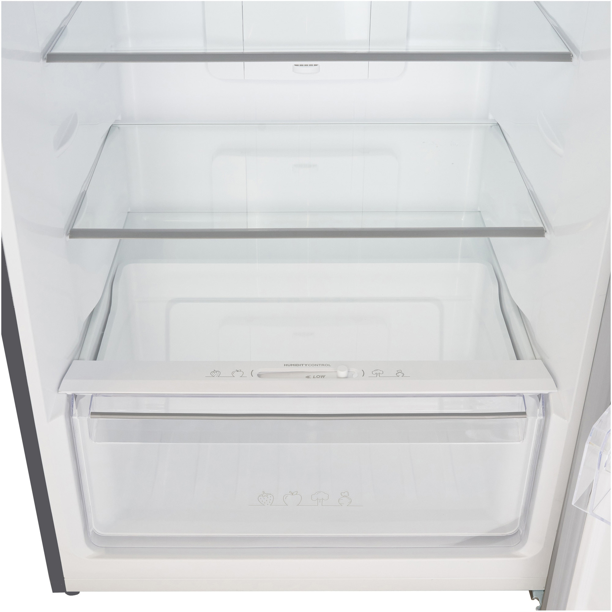 Empty refrigerator interior with glass shelves and a humidity control drawer.