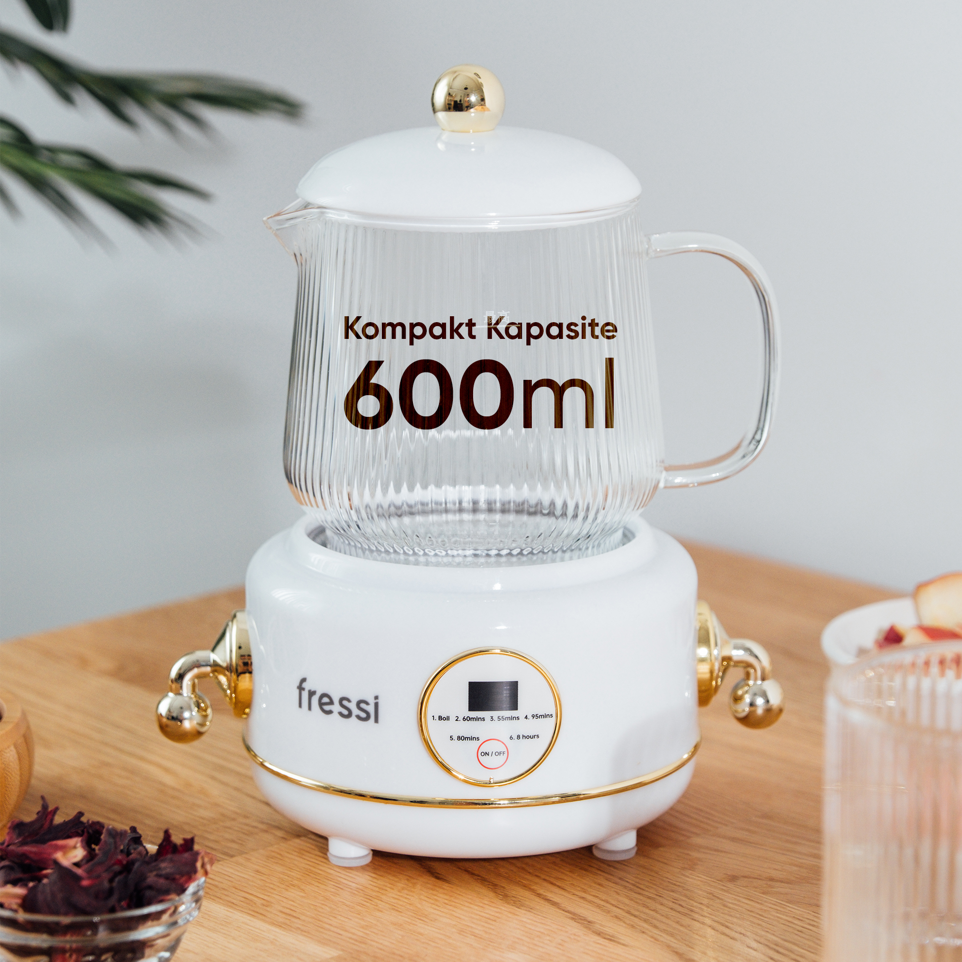 Altın süslemeli beyaz bir tabanda duran beyaz 600ml kapasiteli çaydanlık.