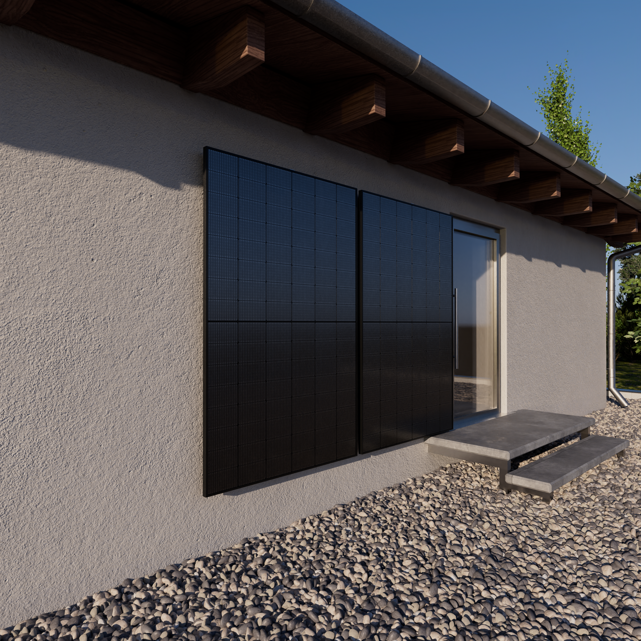 Schwarze Solarmodule an einer Hauswand mit Kieselsteinen und einer Tür.