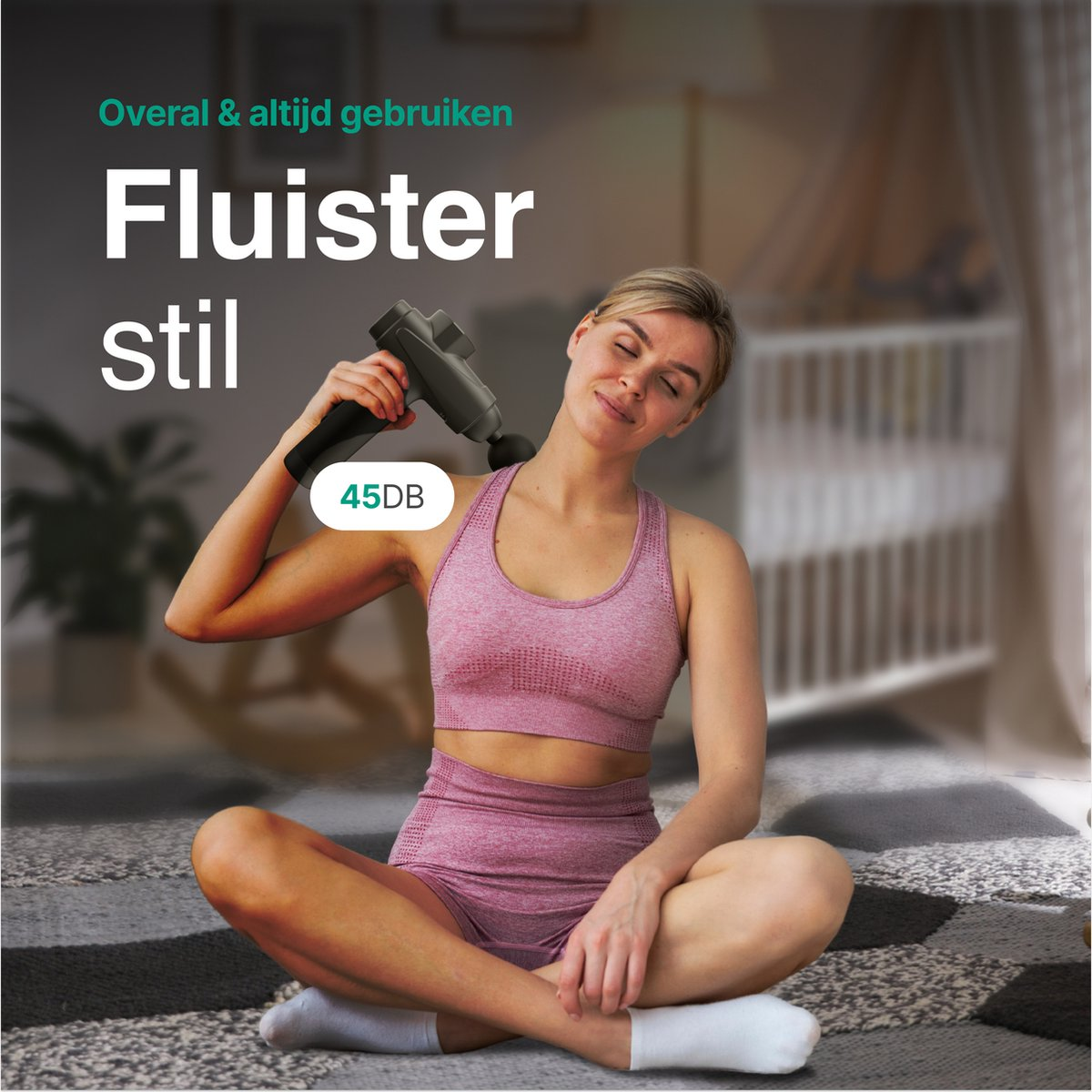Woman using massage gun on neck, sitting cross-legged on floor.