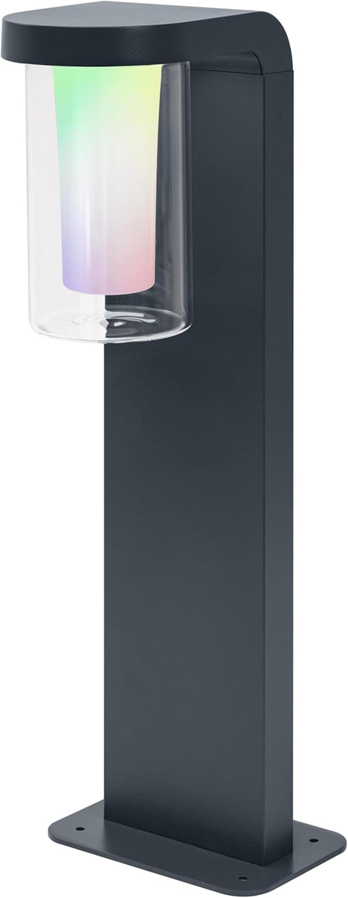Eine dunkle Säulenleuchte mit zylindrischem Glas, das in Regenbogenfarben leuchtet.