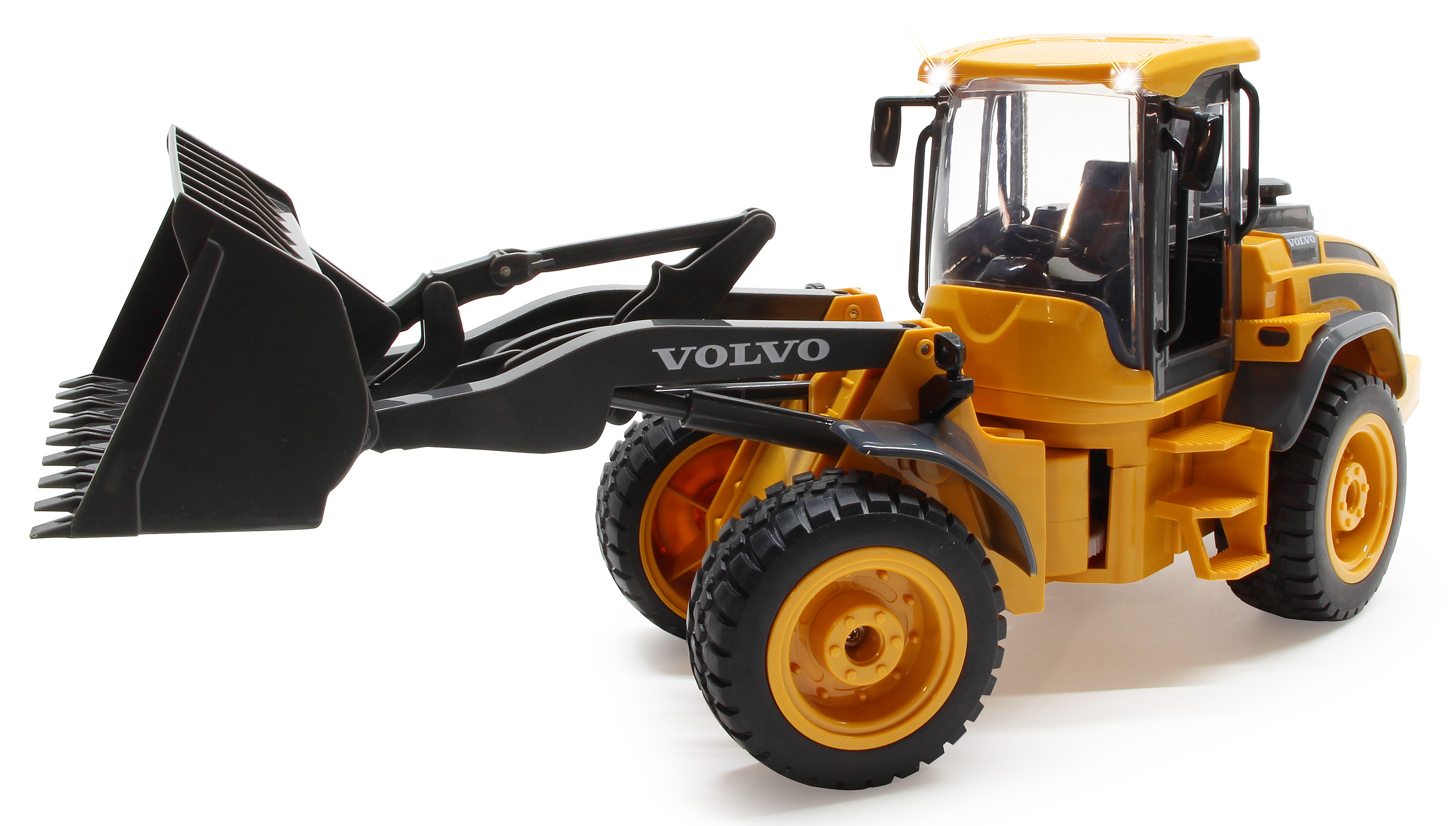 Ein gelber Spielzeug-Radlader mit schwarzer Schaufel und Volvo-Aufschrift.
