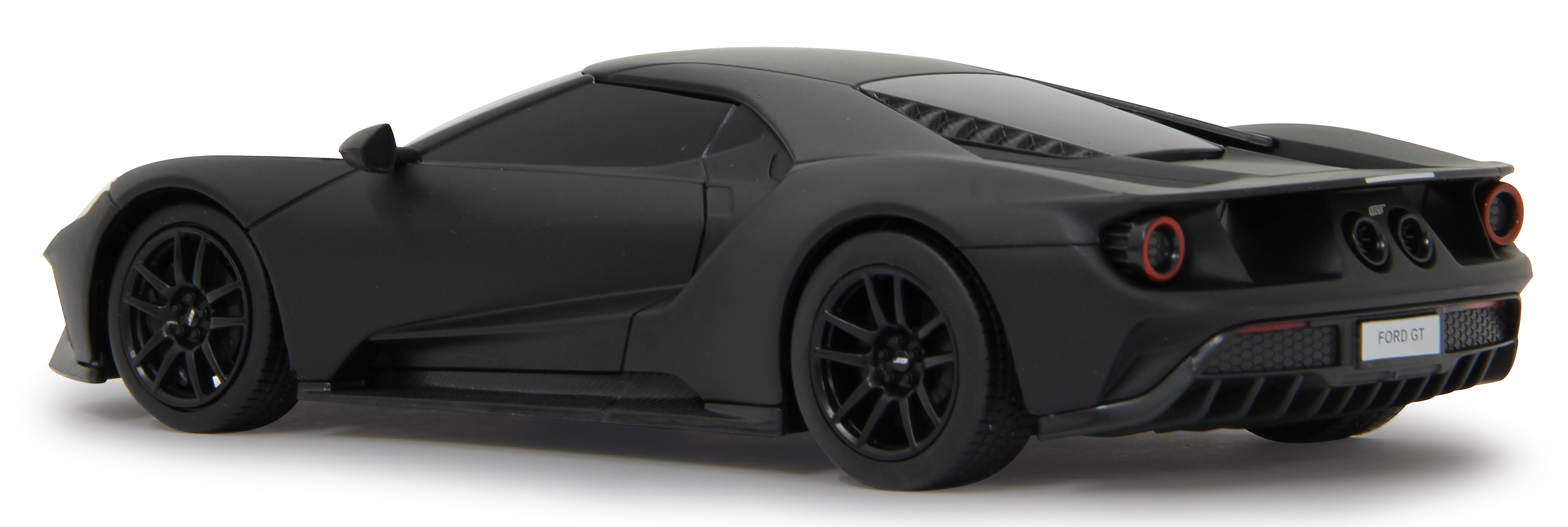Schwarzes Ford GT-Spielzeugauto von hinten, mit roten Rückleuchten und Auspuffrohren.