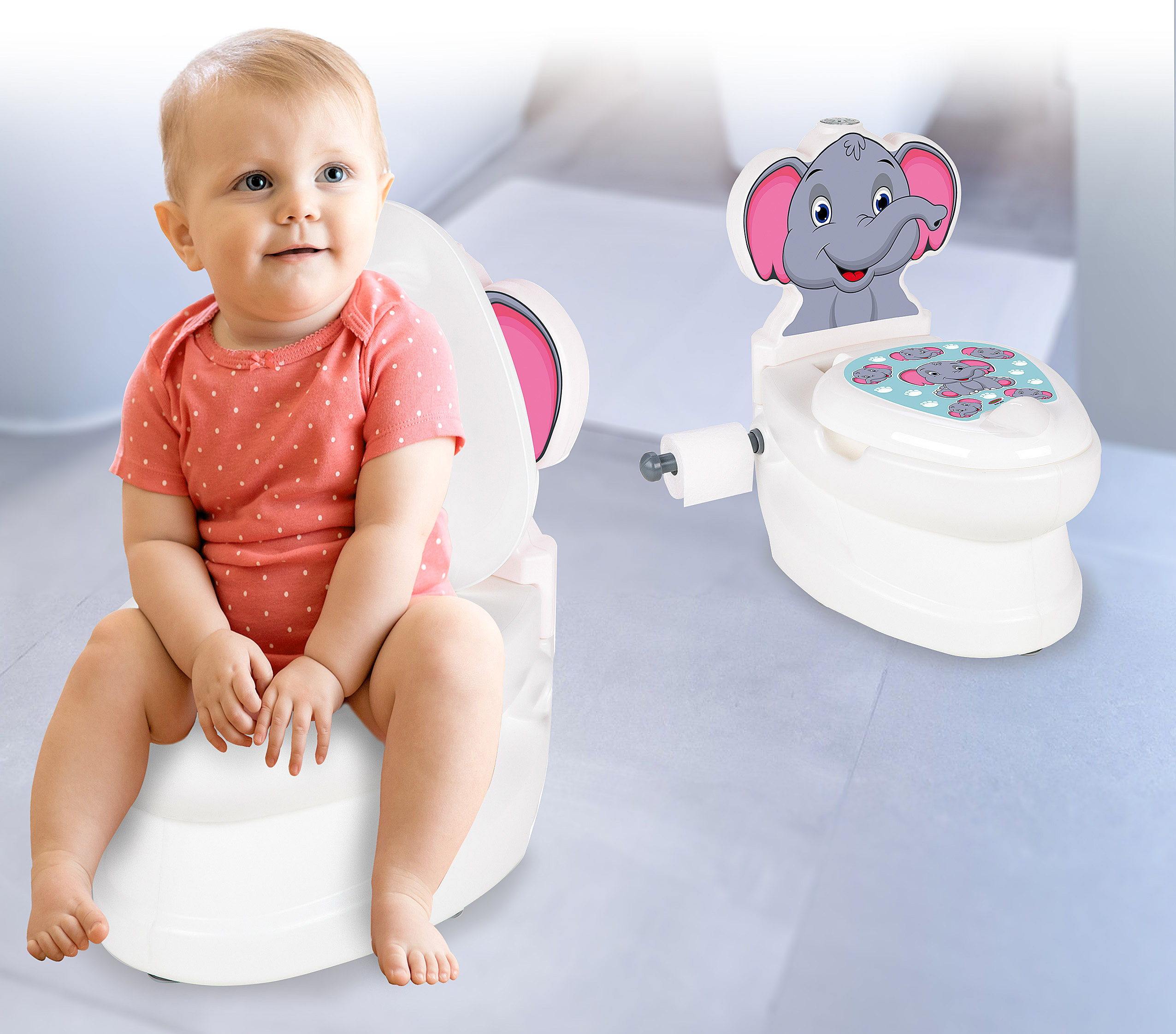 Ein Baby sitzt auf einer rosa Töpfchen-Toilette. Daneben steht eine weiße Kindertoilette mit Elefantenmotiv.