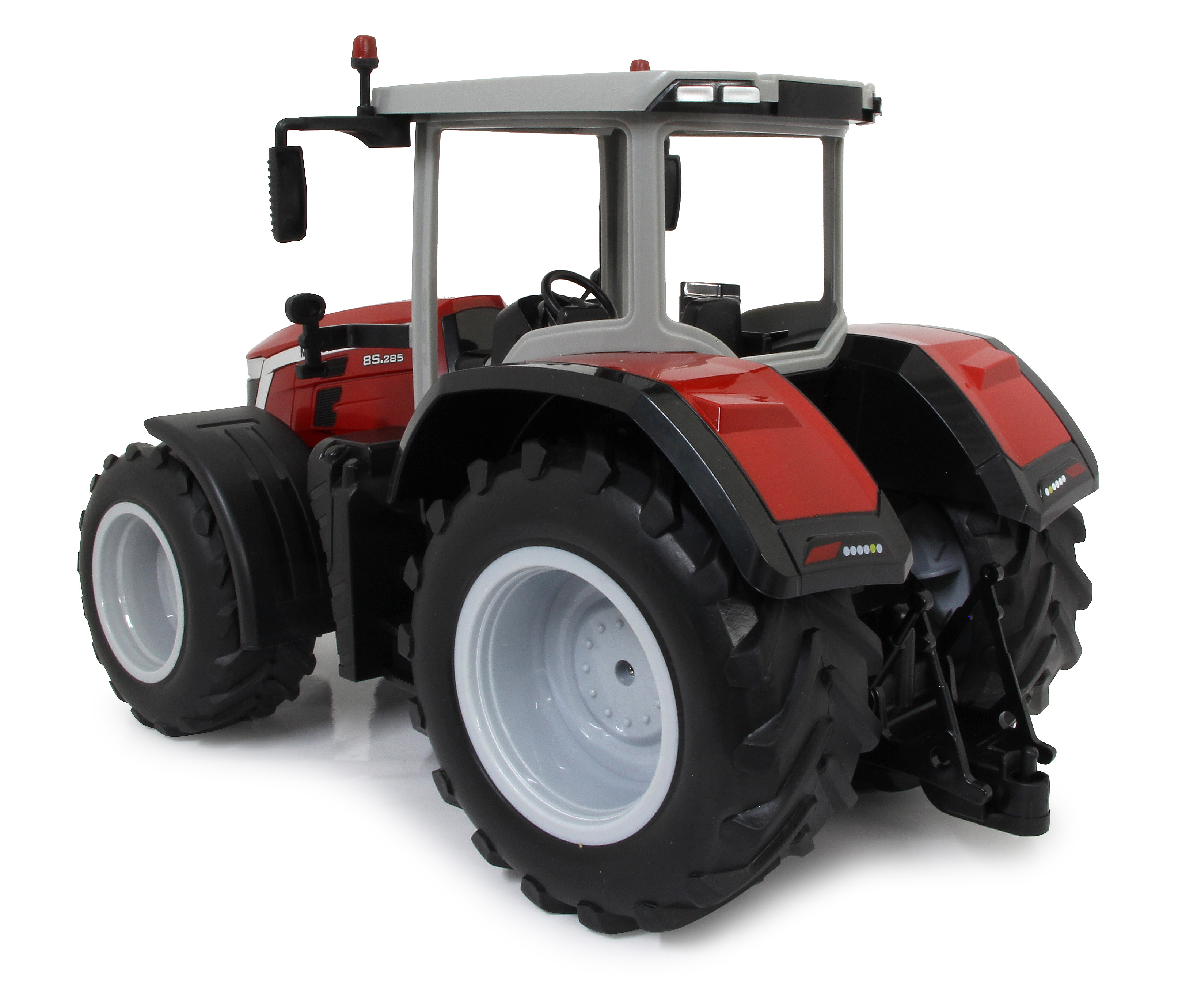 Roter Spielzeugtraktor mit großen Reifen, Kabine und Lichtern.