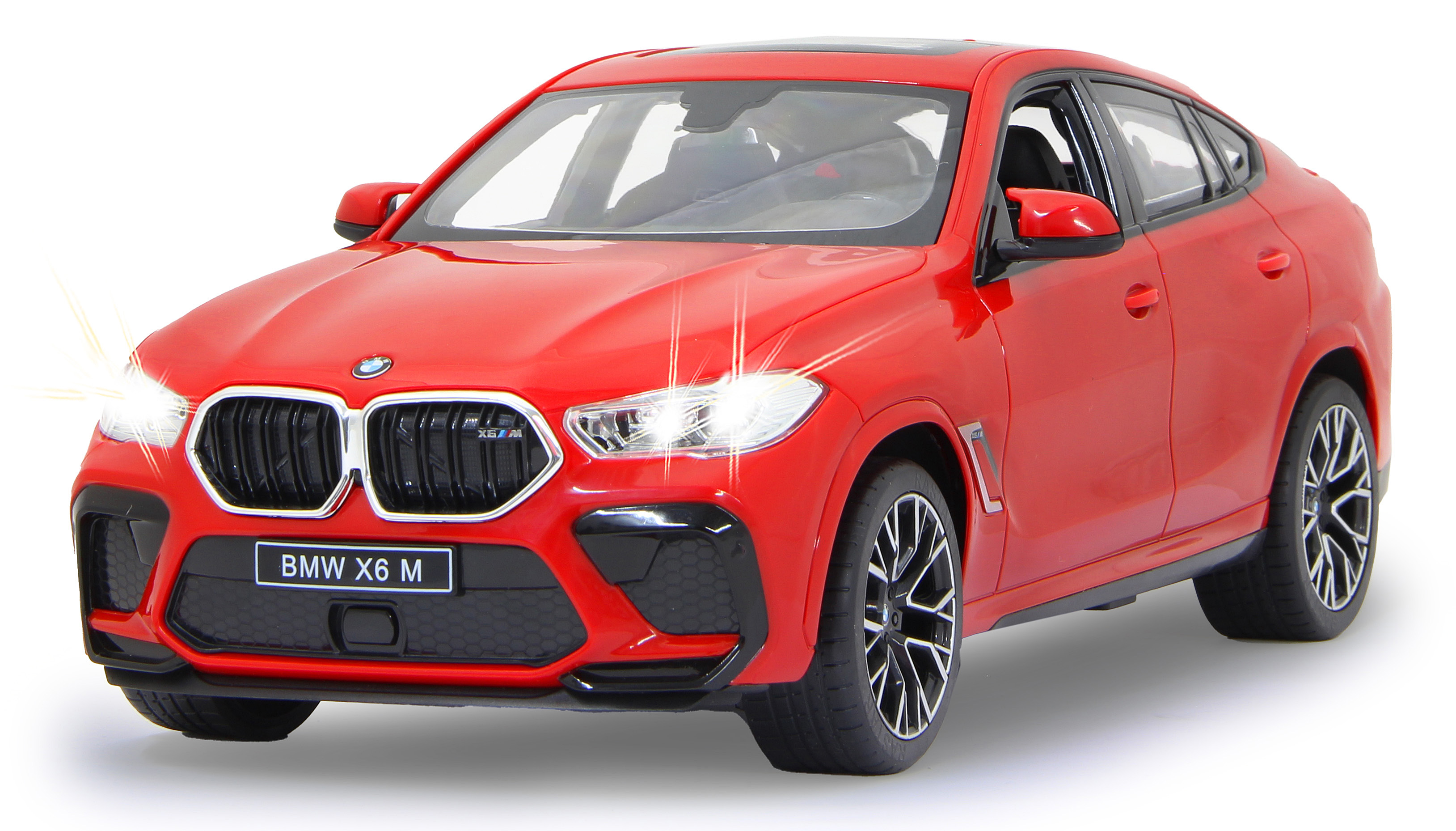 Ein roter BMW X6 M mit leuchtenden Scheinwerfern steht auf weißem Grund.