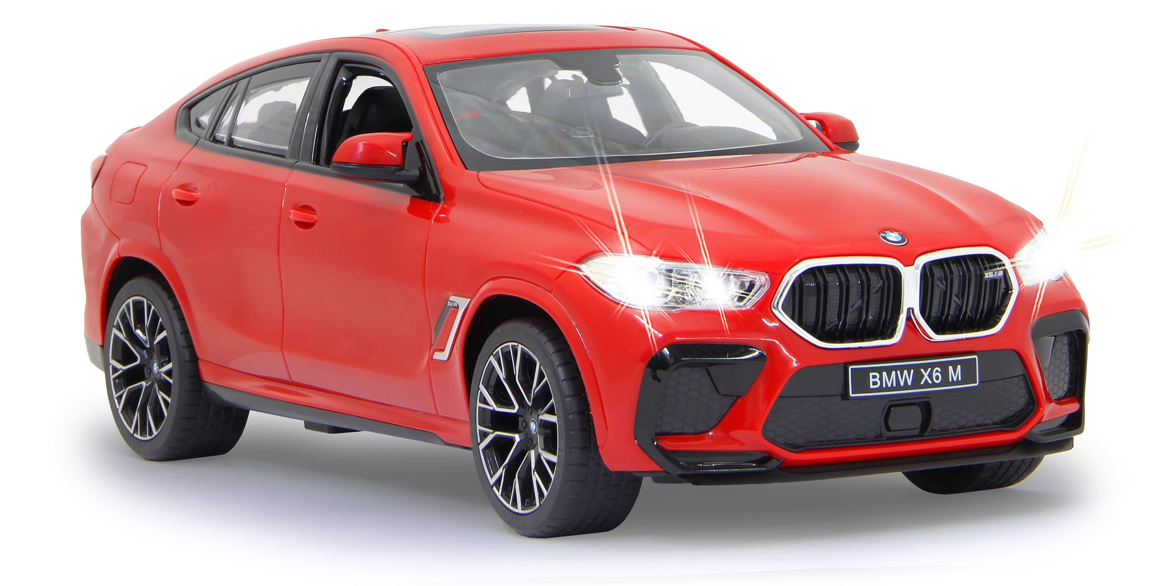 Ein rotes BMW X6 M Spielzeugauto mit leuchtenden Scheinwerfern.