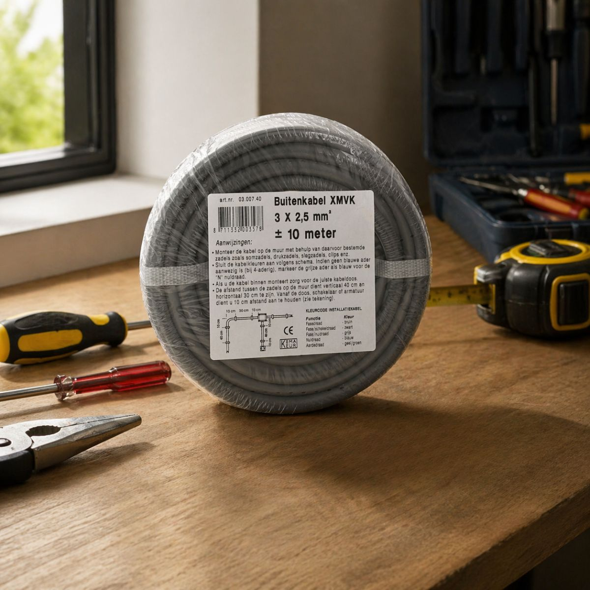 A coiled grey outdoor cable with a label, lying on a wooden table.