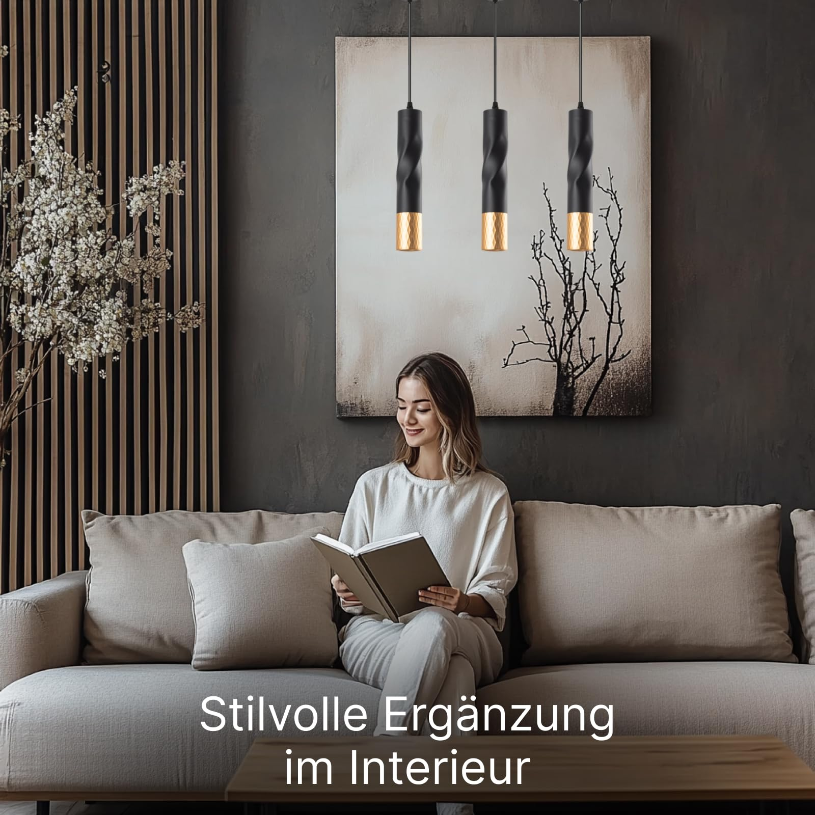 Frau liest auf Sofa, drei Hängelampen über ihr, Kunst an Wand.
