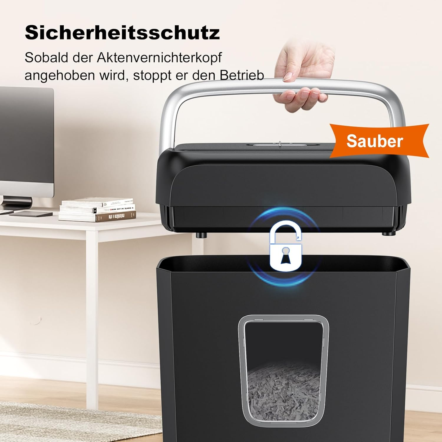 Ein schwarzer Aktenvernichter mit einem Griff, der angehoben wird. Ein Sicherheitssymbol ist sichtbar.
