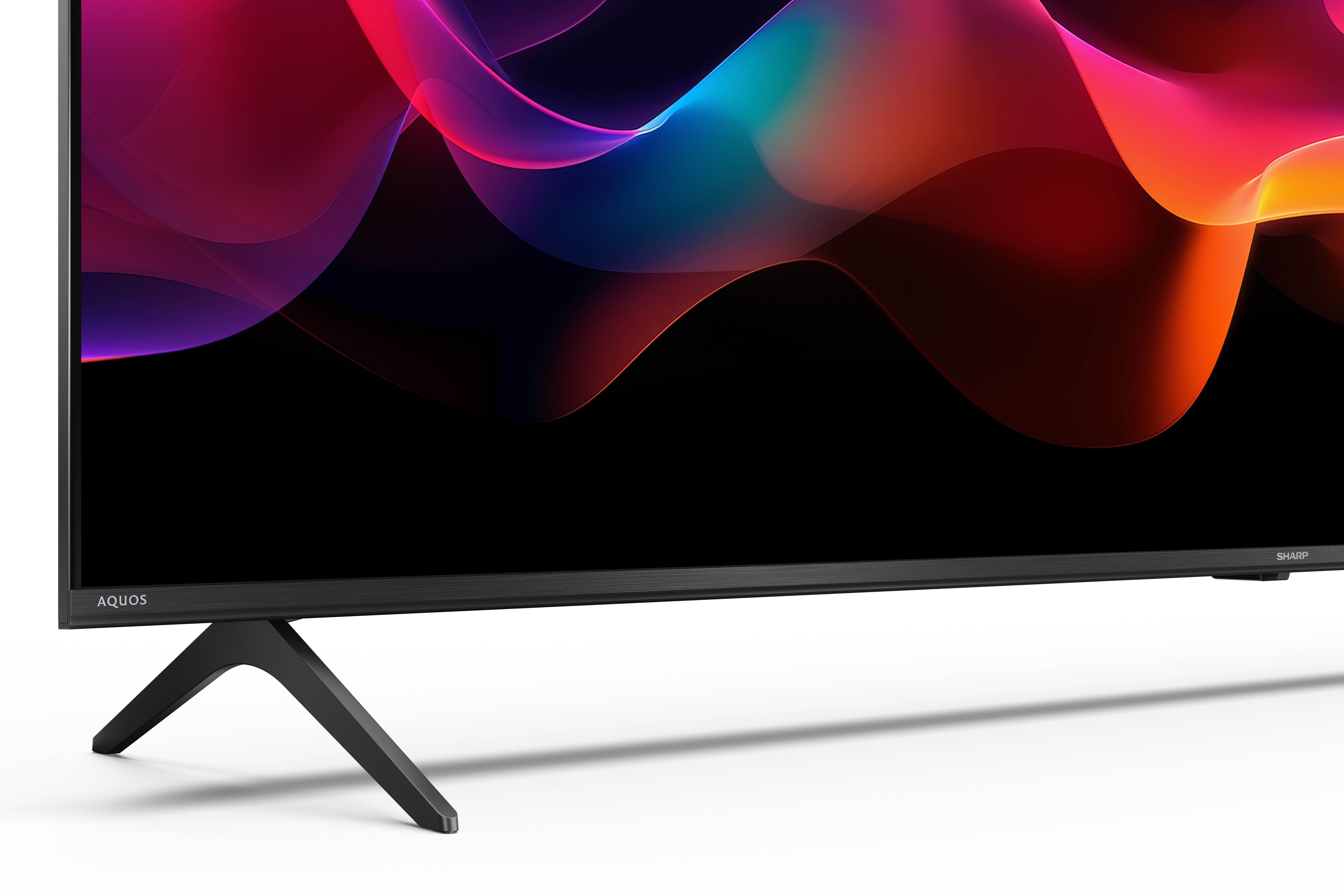 Ein moderner Fernseher mit einem abstrakten, bunten Hintergrund und schwarzen Standfüßen.