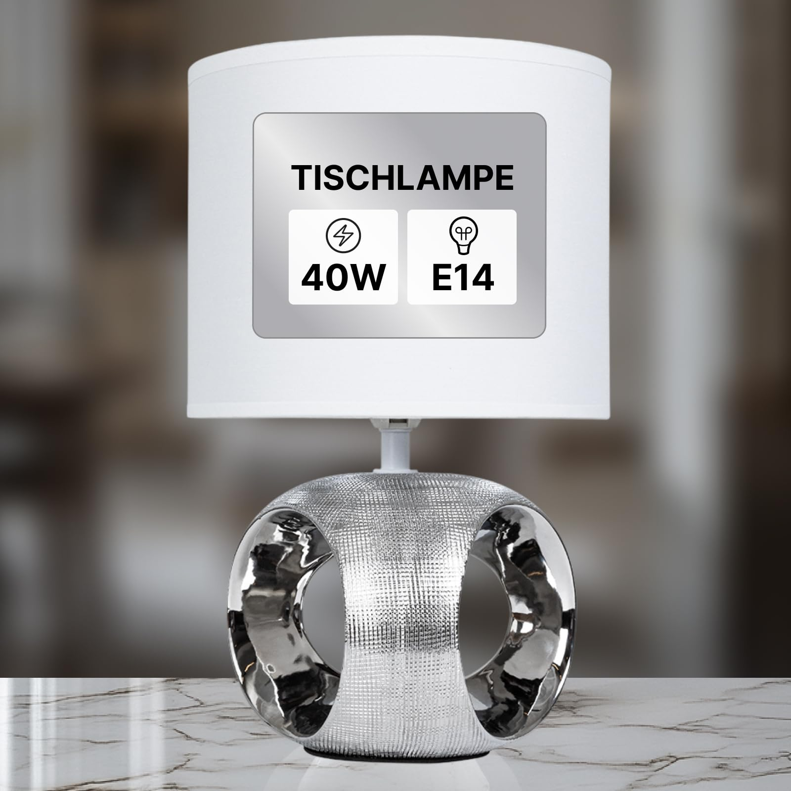 Eine silberne Tischlampe mit einem zylindrischen Lampenschirm und einem Ringfuß.
