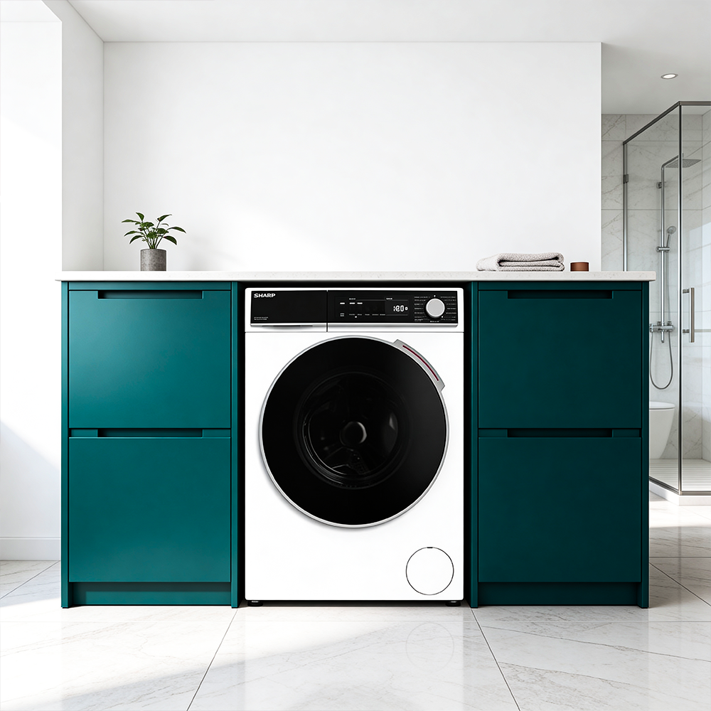 A washing machine between two deep green cabinets, with a shower enclosure in the background.