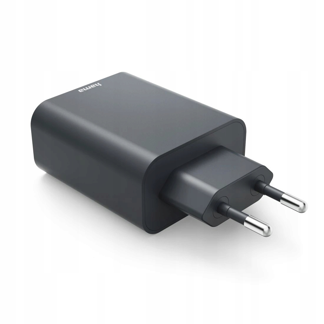 Ciemny adapter podróżny Hama z dwoma metalowymi bolcami na białym tle.
