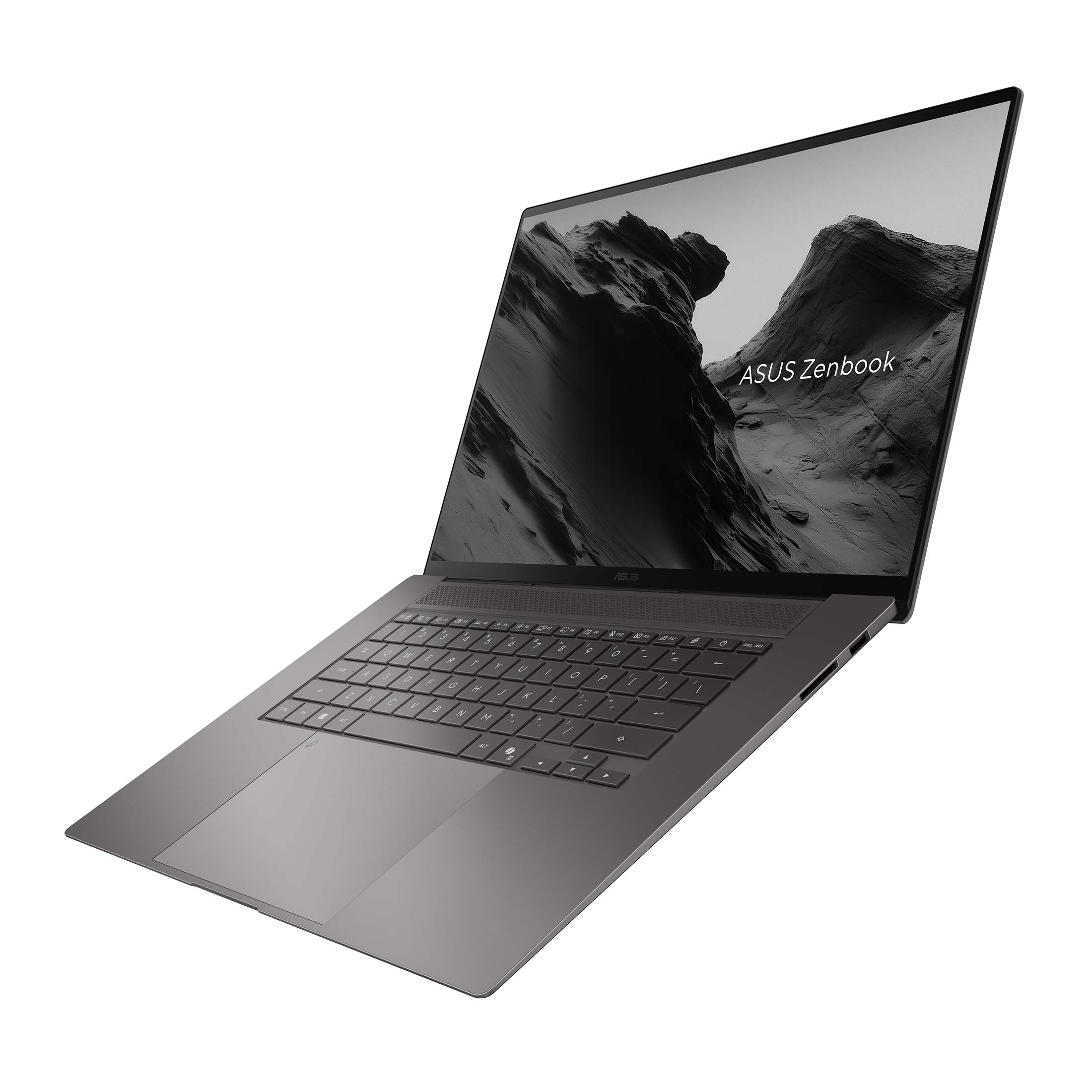 Un ordinateur portable Asus Zenbook gris avec clavier rétroéclairé et une image de montagne à l'écran.
