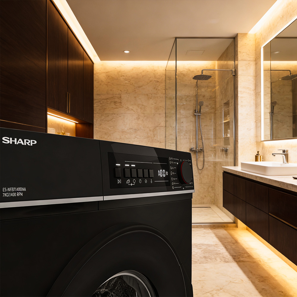 Black washing machine in a modern bathroom with shower and vanity.