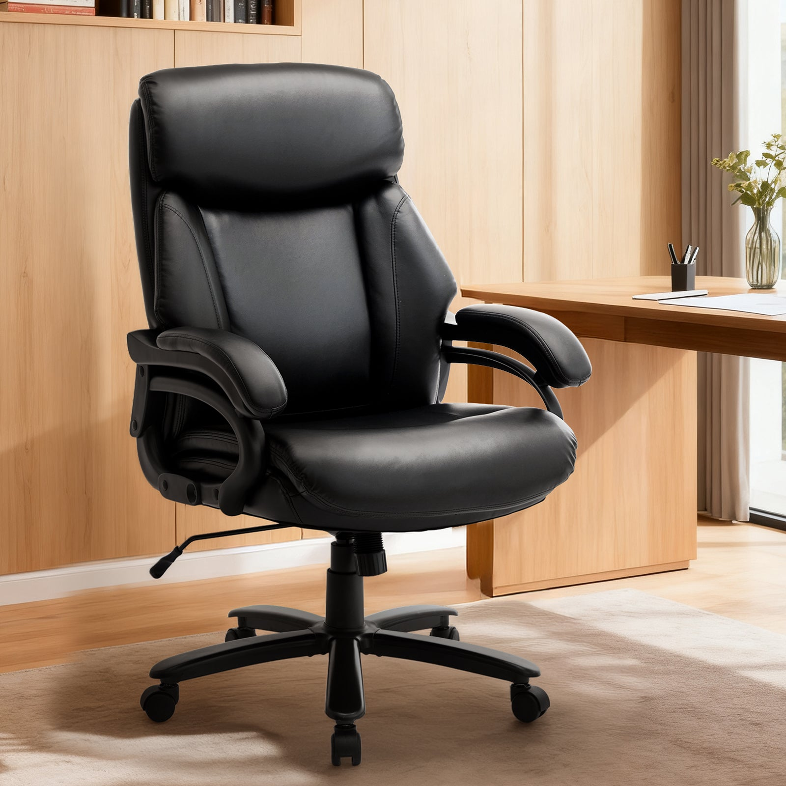 Schwarzer Bürostuhl mit hoher Rückenlehne vor einem Holztisch und Bücherregal.