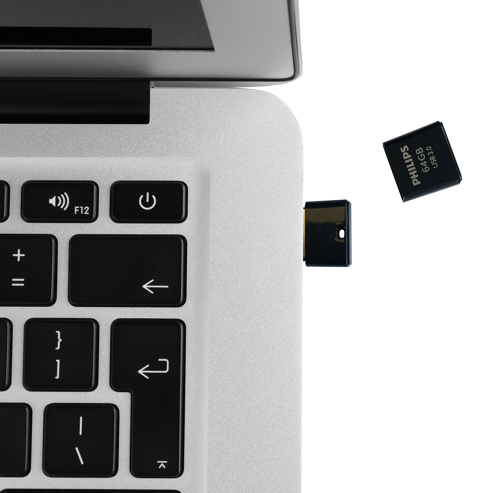 Een Philips 64GB USB 3.0 stick naast een laptop toetsenbord.