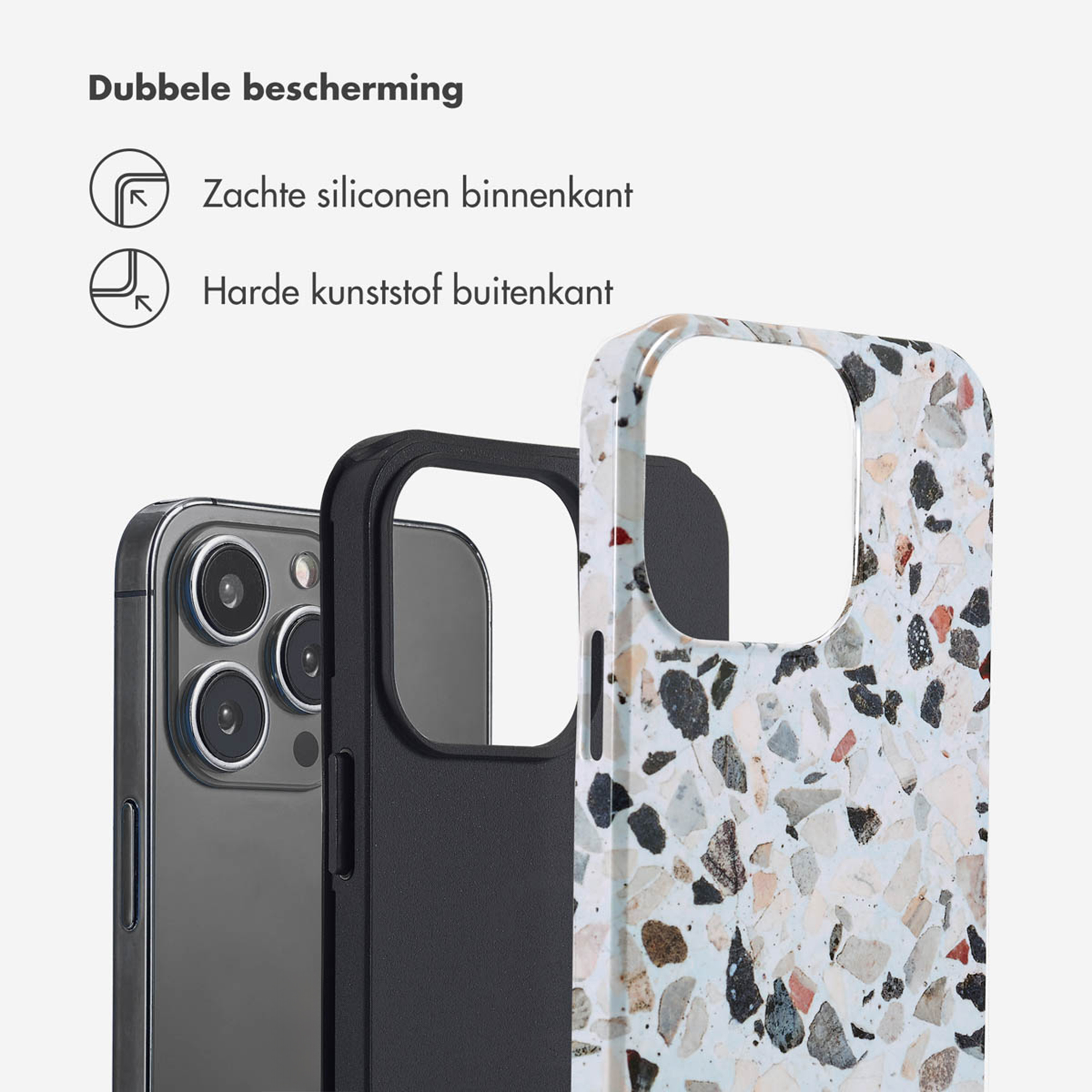 Een telefoonhoesje met terrazzo-patroon naast een telefoon.