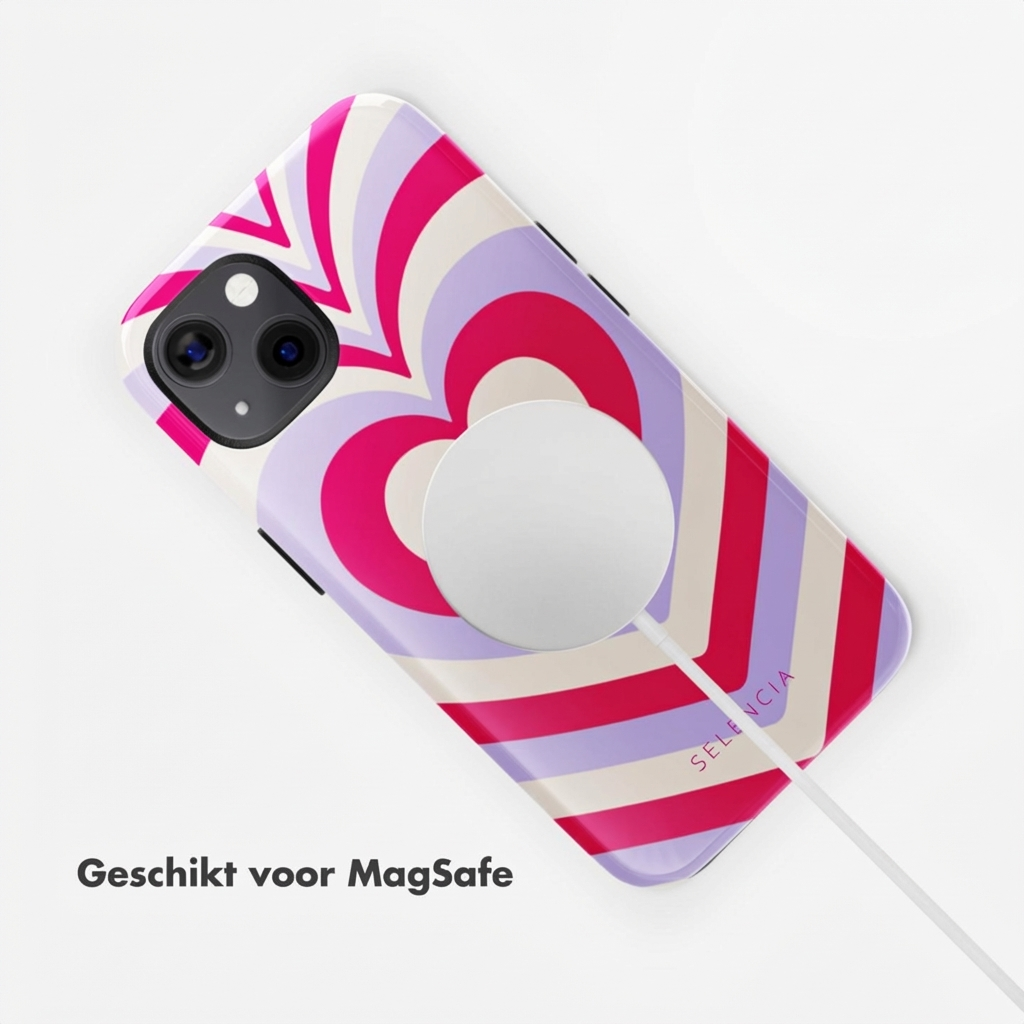 Un iPhone blanc avec un motif de cœur coloré et chargeur MagSafe.