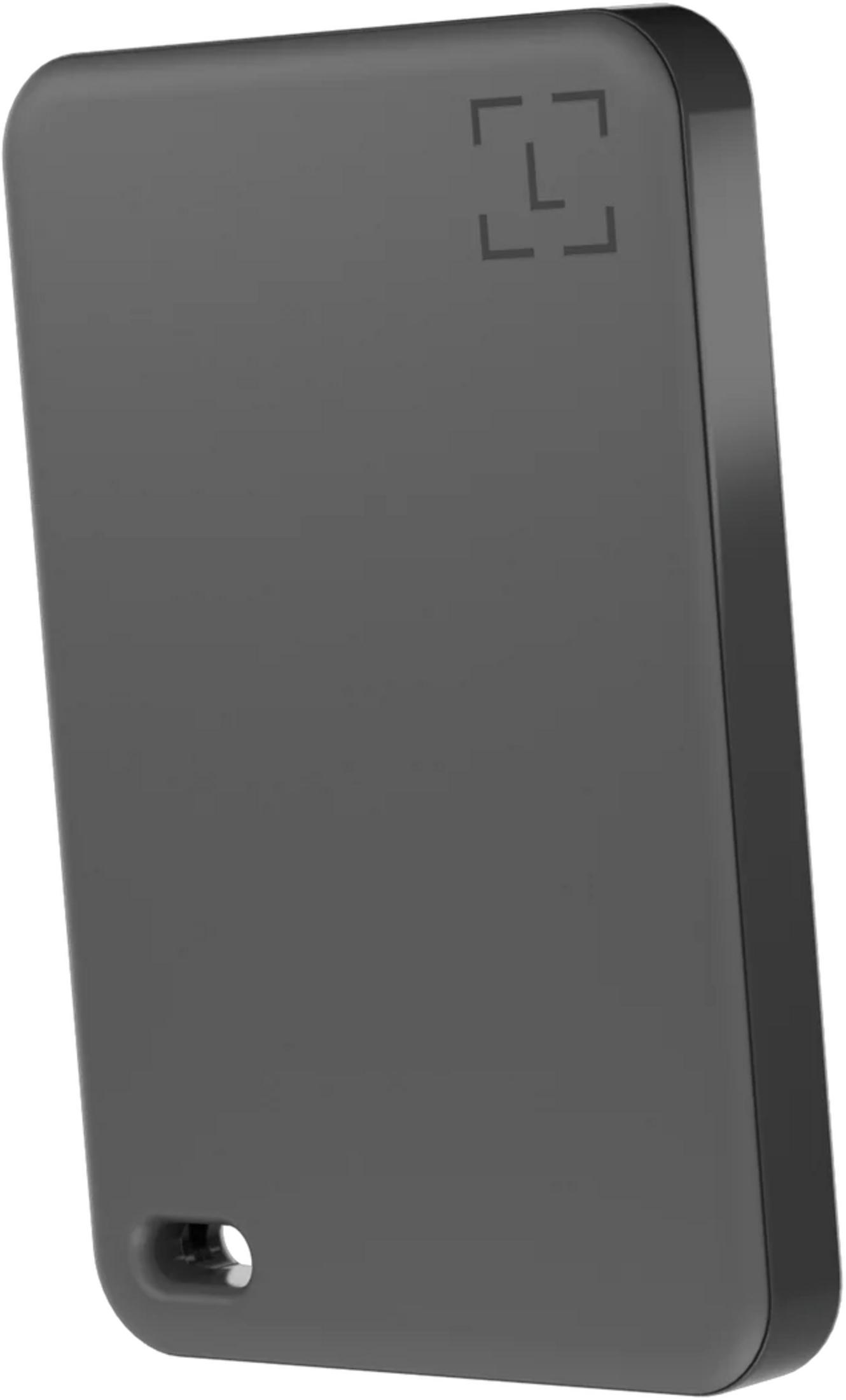 Appareil rectangulaire gris avec une icône en haut à droite et un trou en bas à gauche.