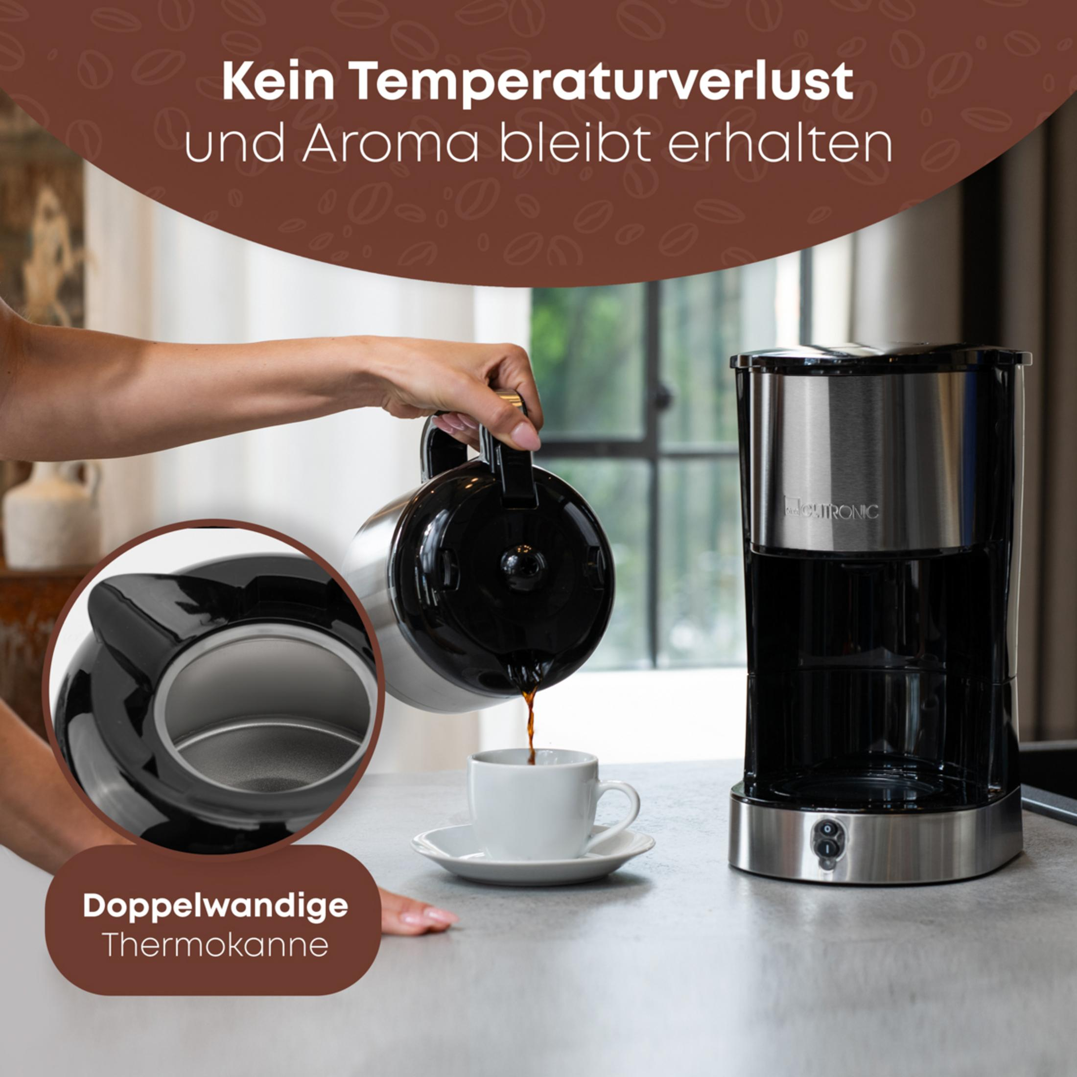 A thermos jug pours coffee into a cup next to a coffee maker.