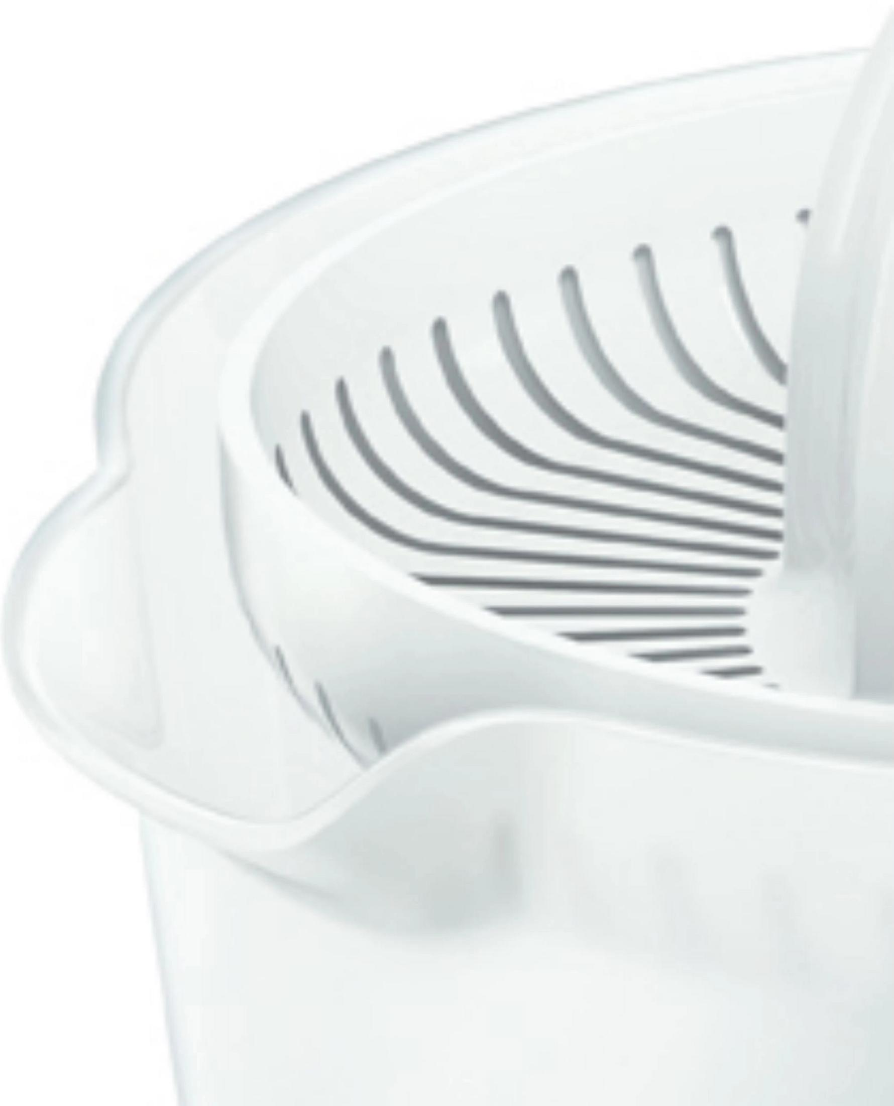 A white citrus juicer insert with slots for juice drainage.