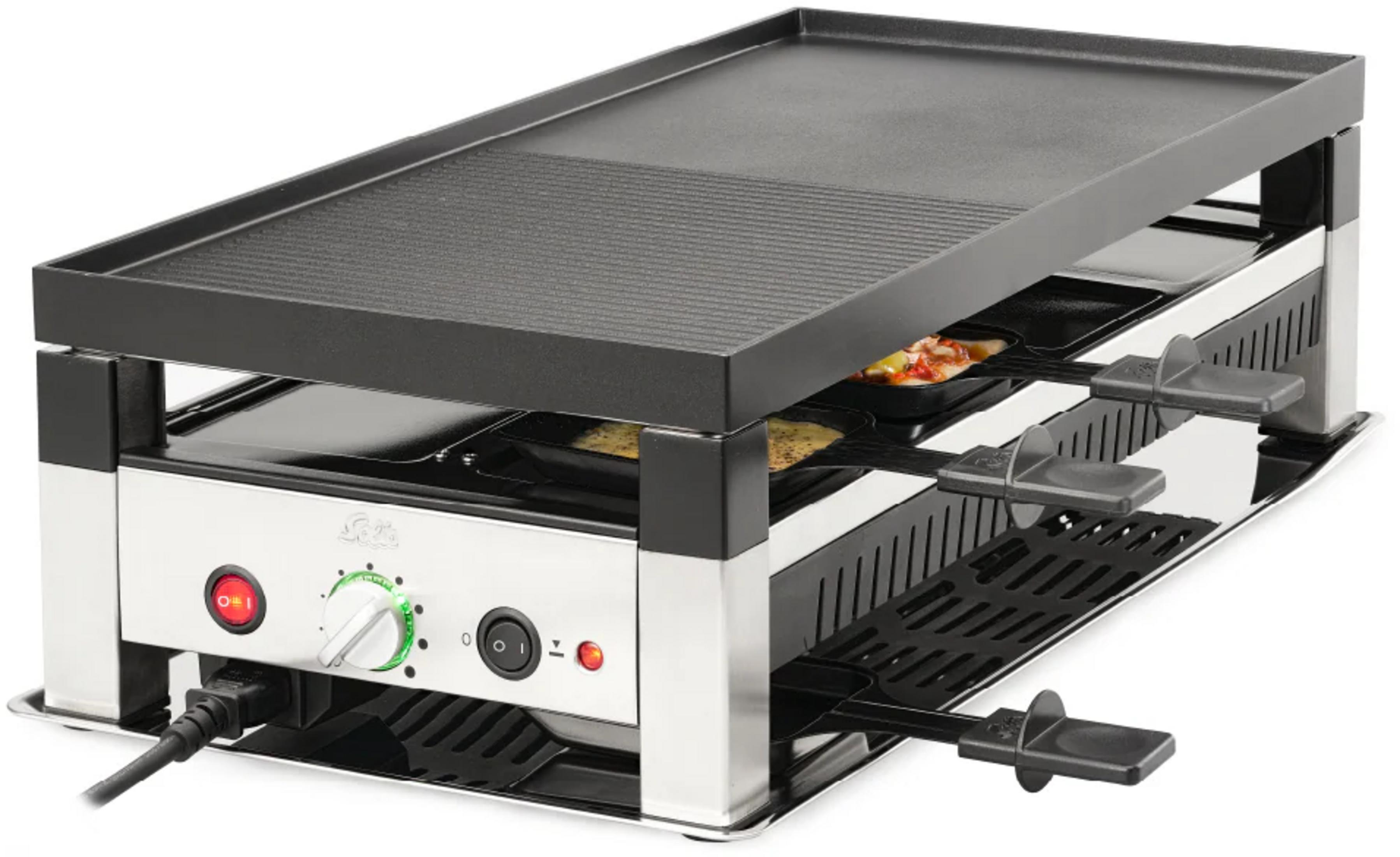 Ein Raclette-Grill mit einer Grillplatte und mehreren Pfannen darunter.