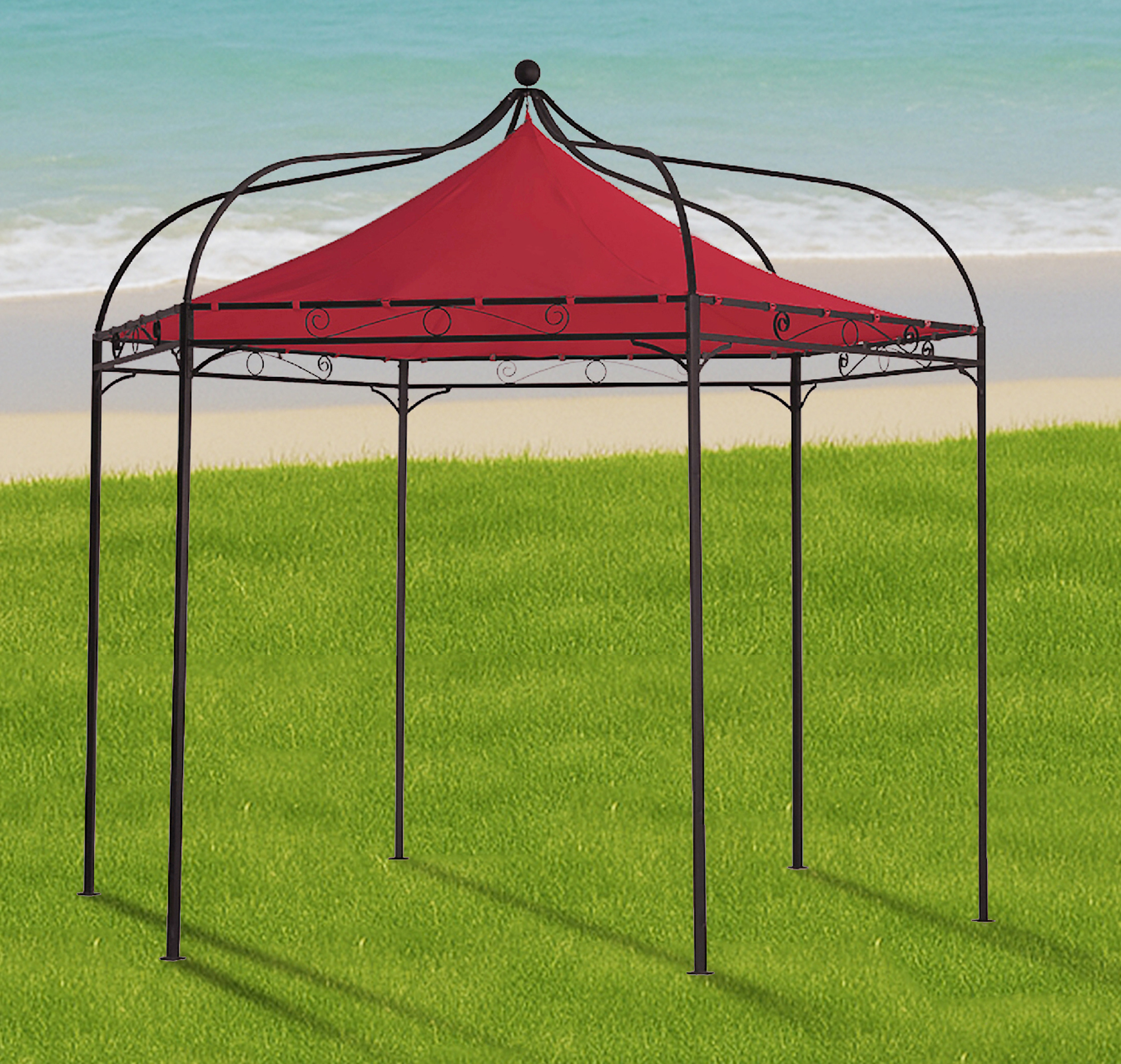 Ein roter Pavillon mit schwarzem Metallgestell steht auf grünem Gras am Strand.