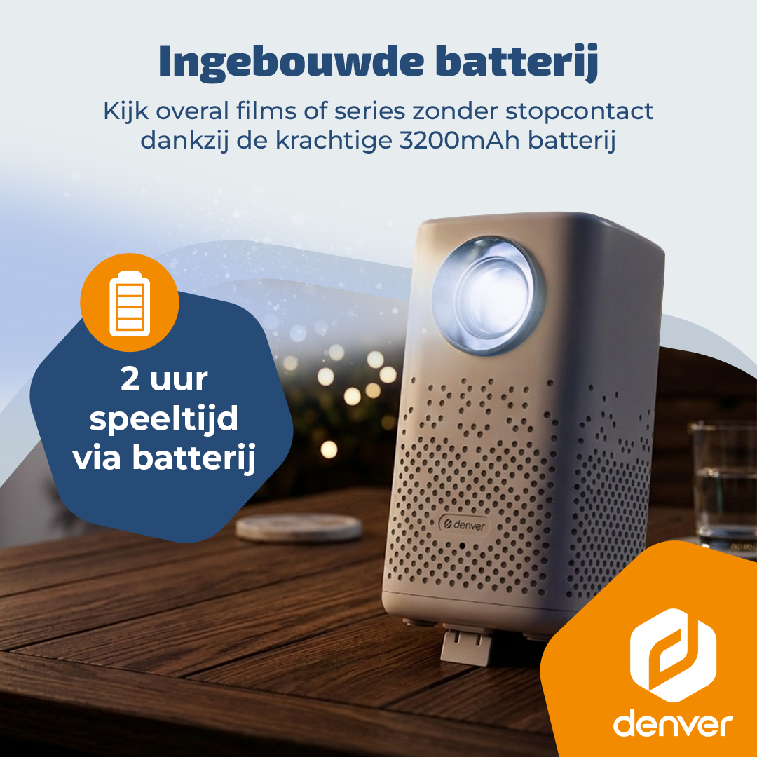 Un projecteur gris avec batterie intégrée sur une table en bois. 2 heures d'autonomie.