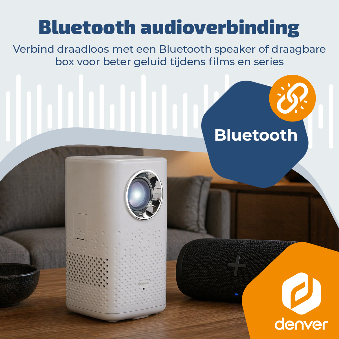Un projecteur blanc et une enceinte Bluetooth noire sur une table en bois.