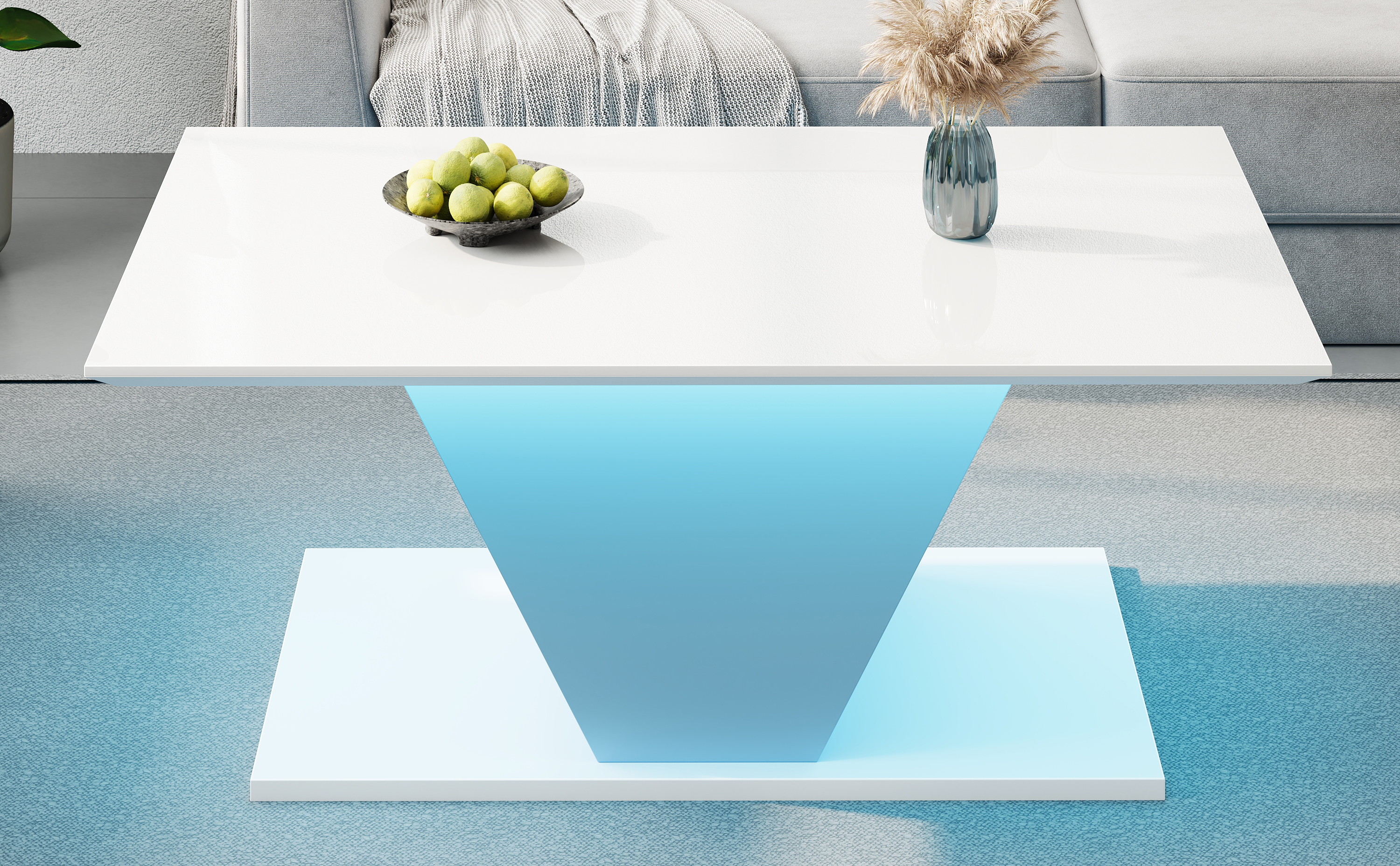 Moderner weißer Couchtisch mit blau beleuchtetem Sockel, Obstschale und Vase.