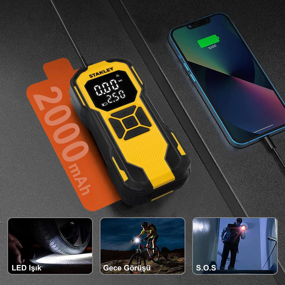 Un gonfiatore per pneumatici giallo e nero accanto a uno smartphone completamente carico.