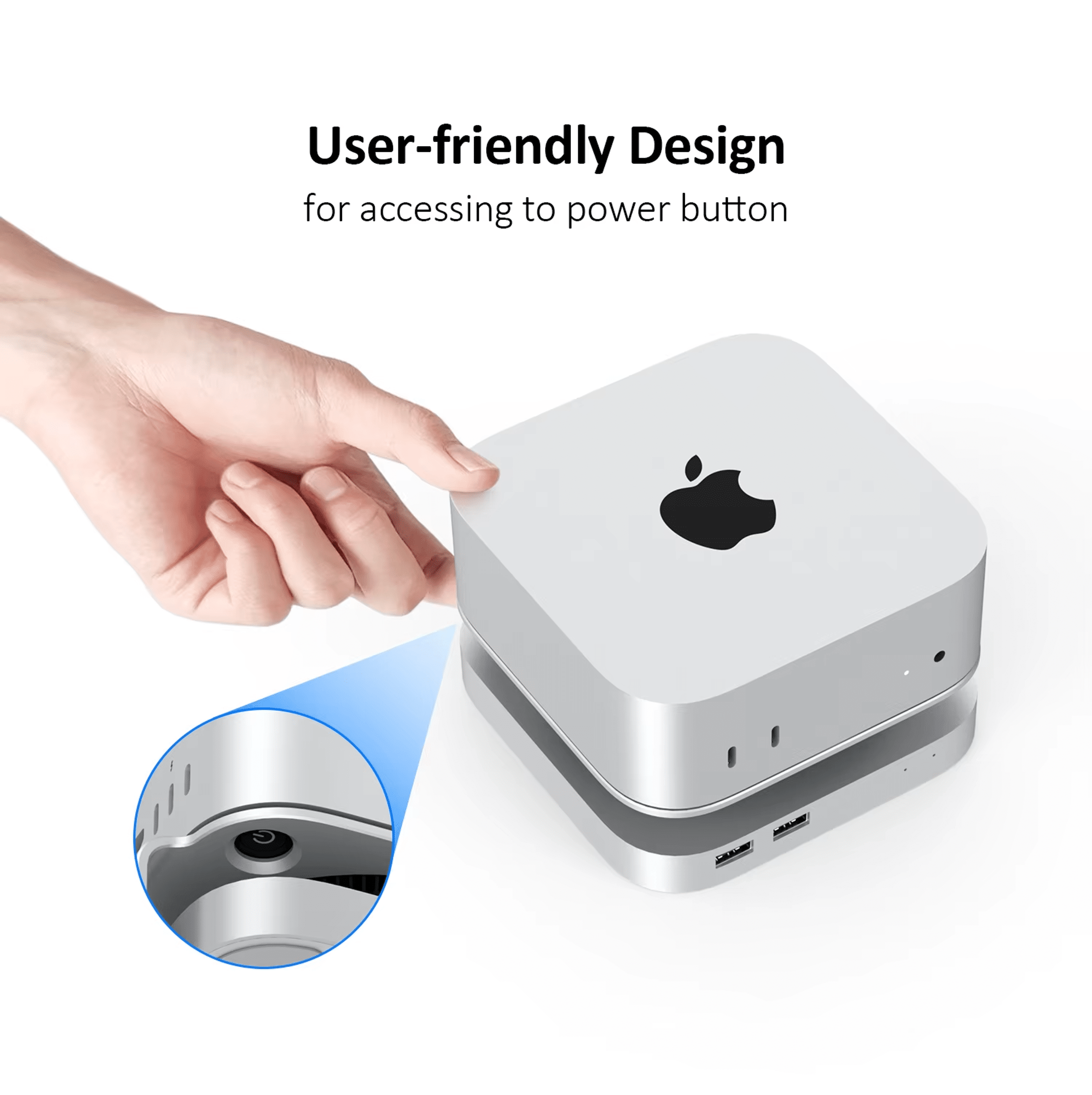 A hand presses the power button on a silver computer. Close-up view.