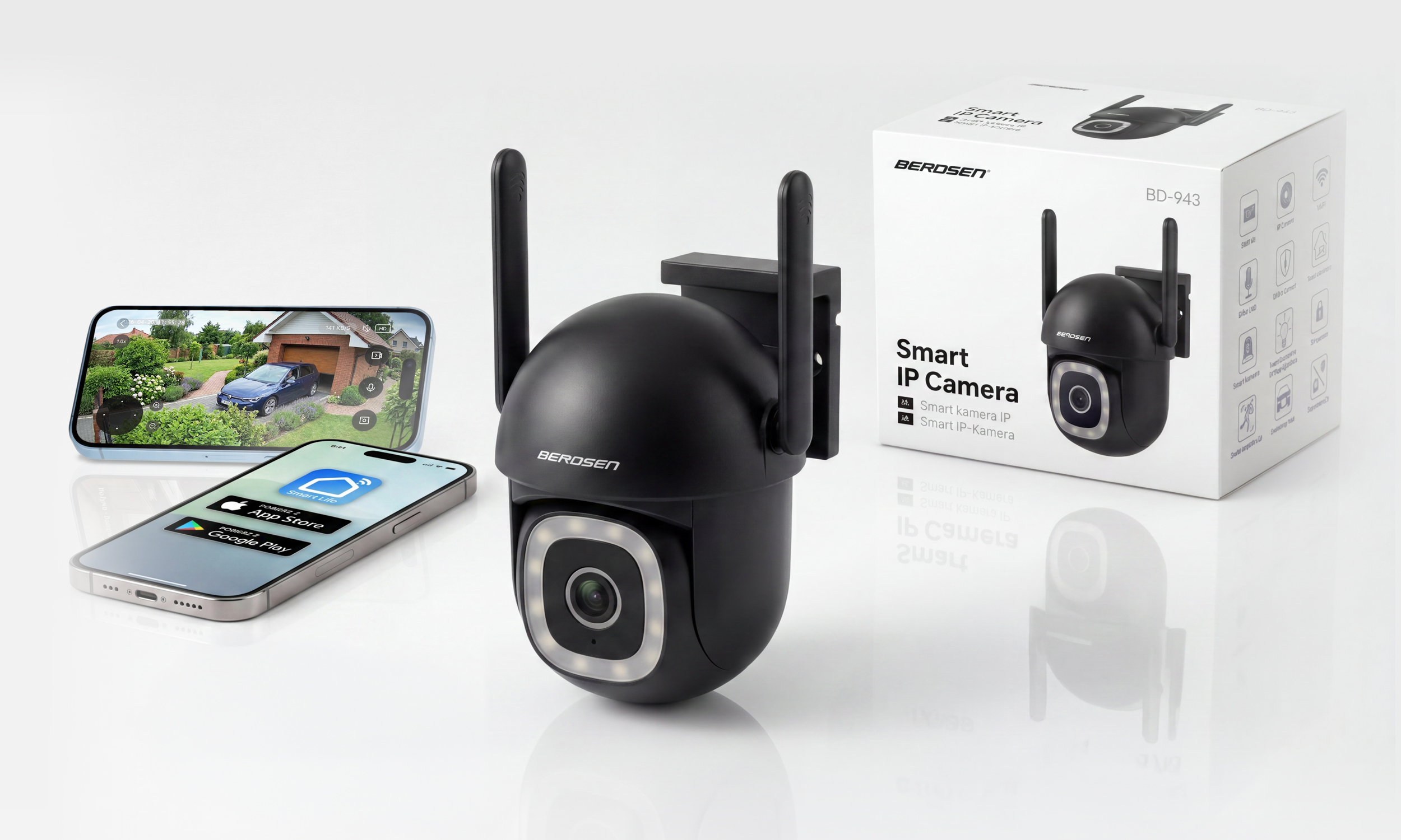 Czarna kamera IP z antenami obok smartfona pokazującego widok domu.