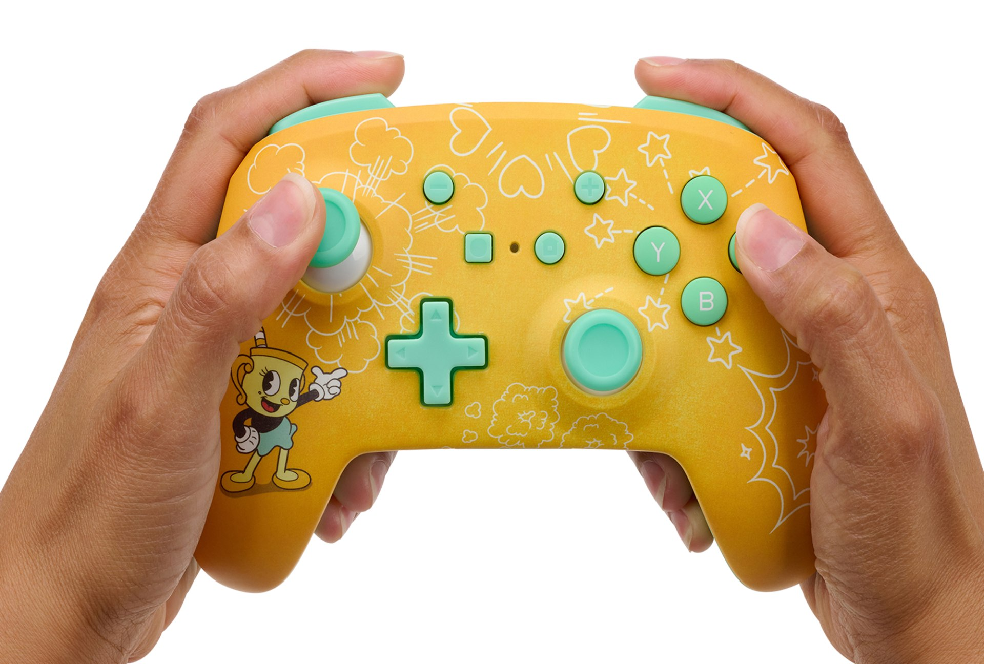 Żółta powierzchnia kontrolera Cuphead z białymi gwiazdami, sercami i chmurami. Trzymają go ręce.