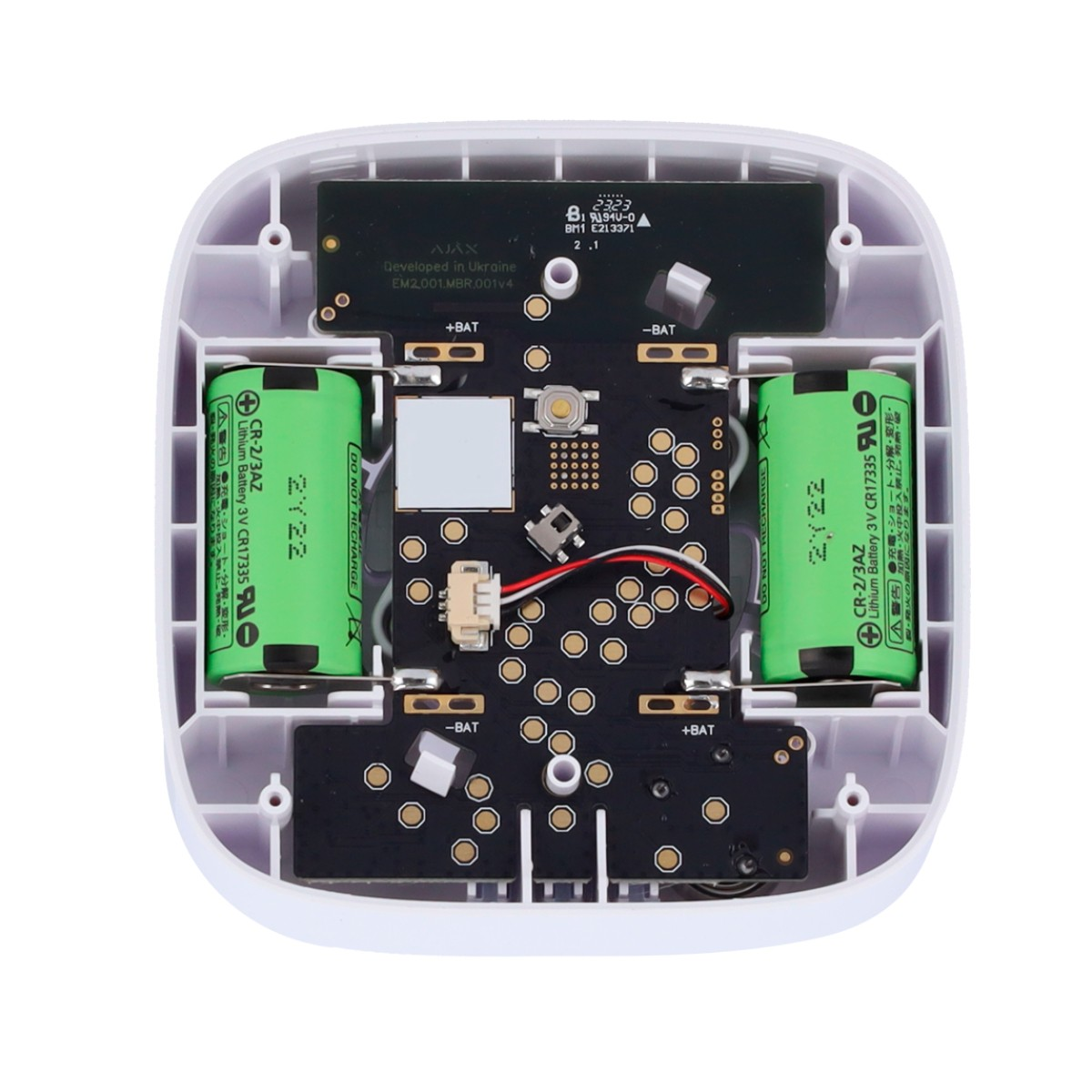 Vista interna di un dispositivo aperto con due batterie al litio verdi da 3V e una scheda elettronica.