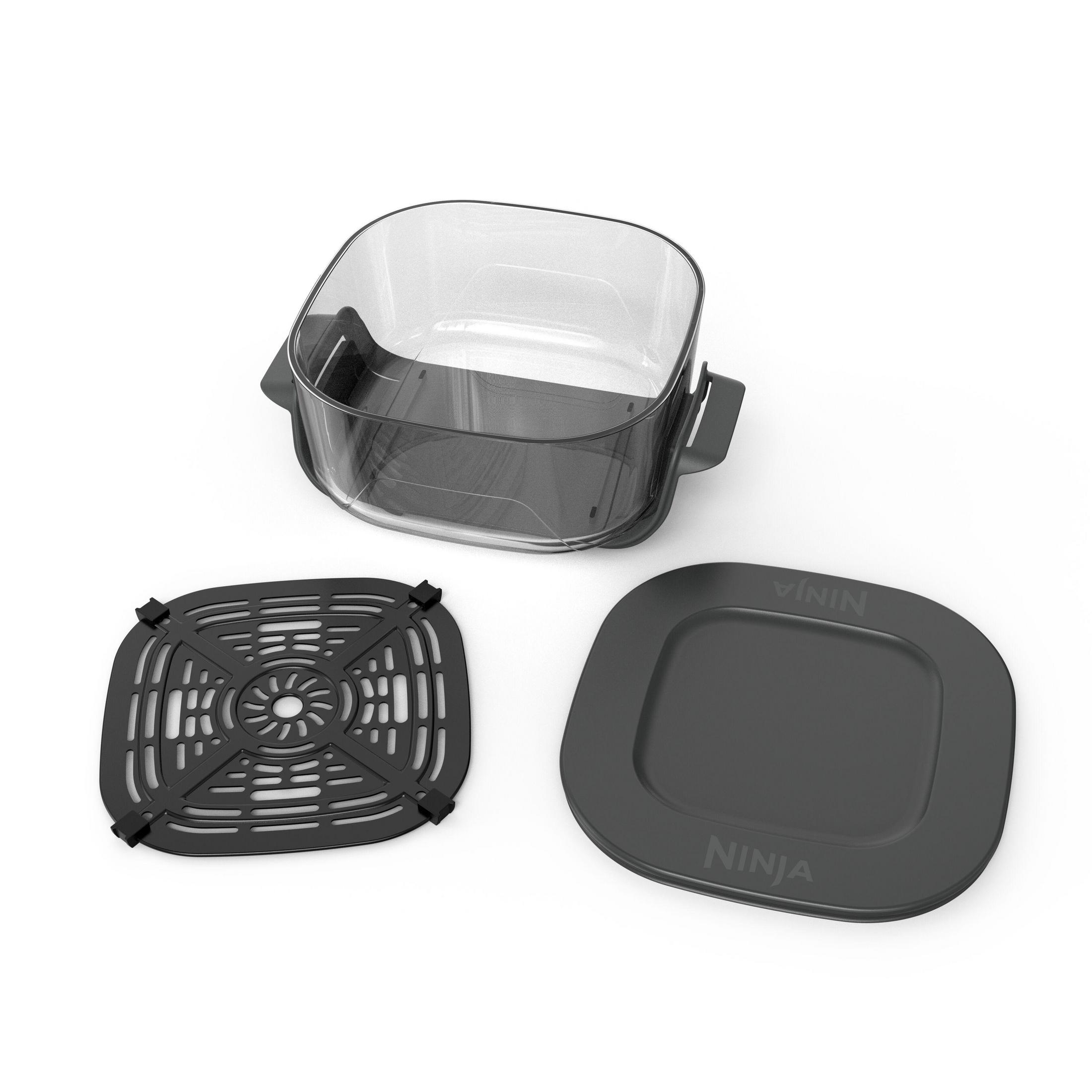 Un contenitore trasparente con inserto nero e coperchio nero.
