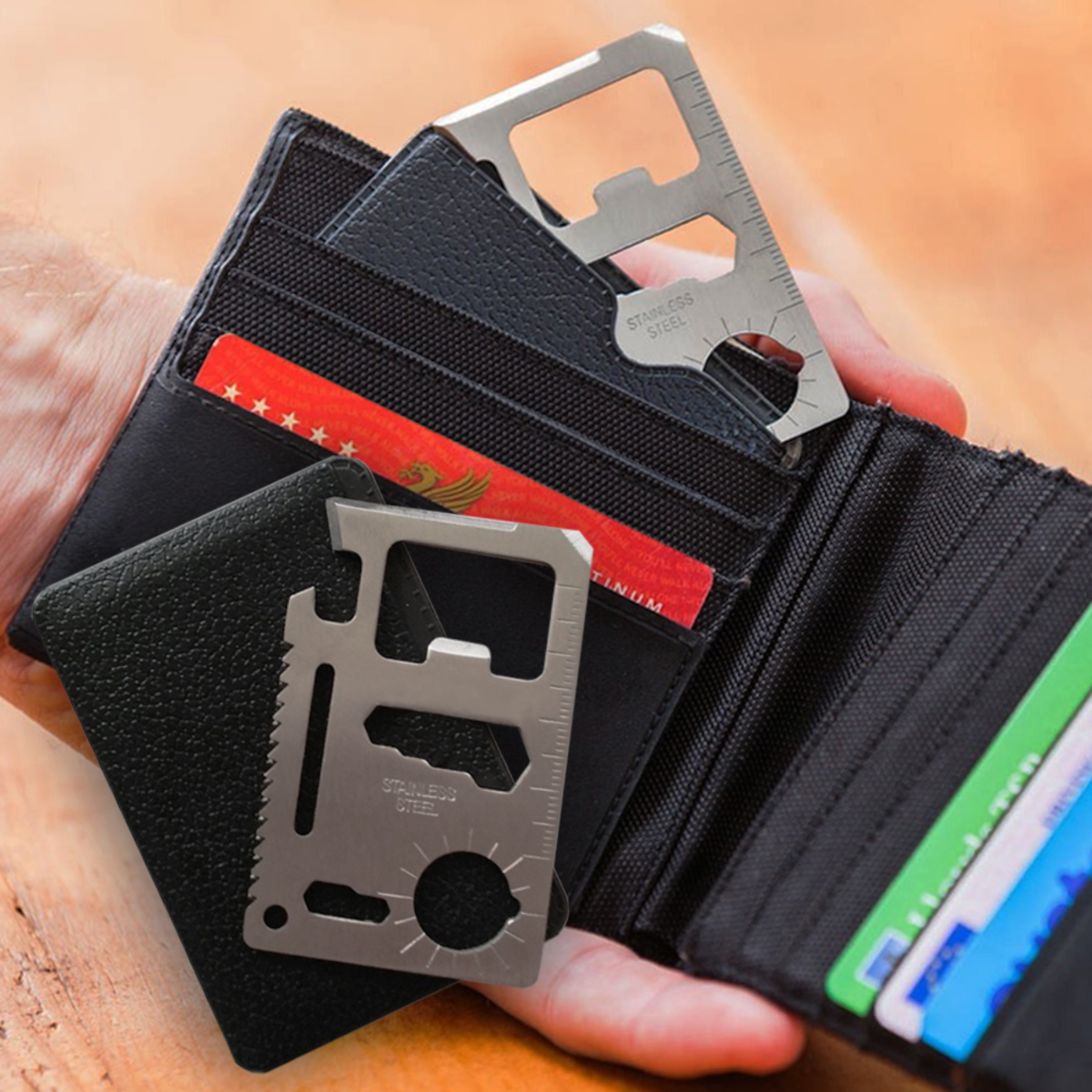 Een persoon houdt een zwarte portemonnee vast met creditcards en een multitool.