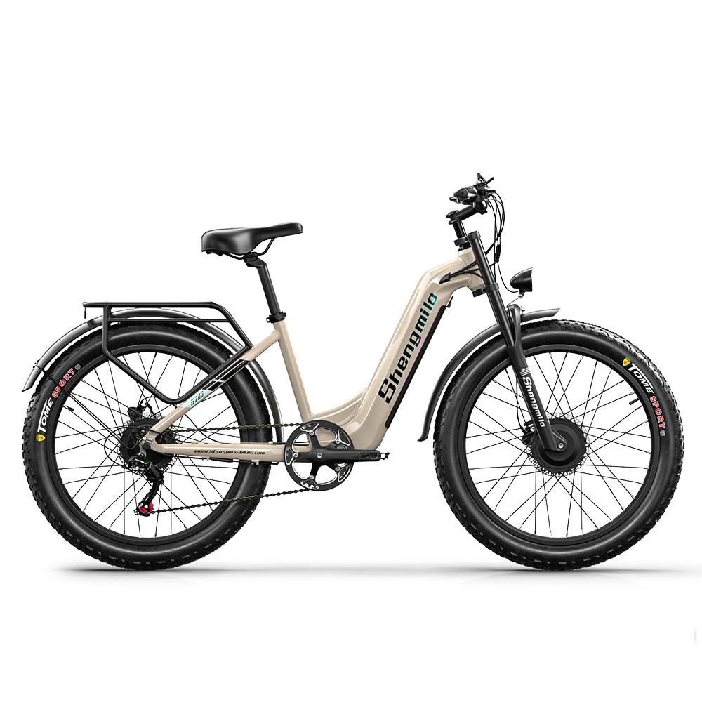 Una e-bike Shengmilo beige con neumáticos anchos, portaequipajes y suspensión.