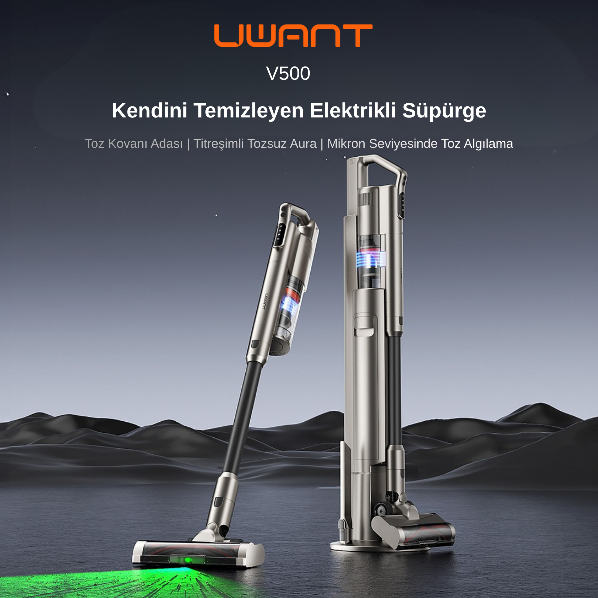 İki gümüş renkli elektrikli süpürge karanlık tepelerin önünde duruyor. Biri yeşil ışıklı.
