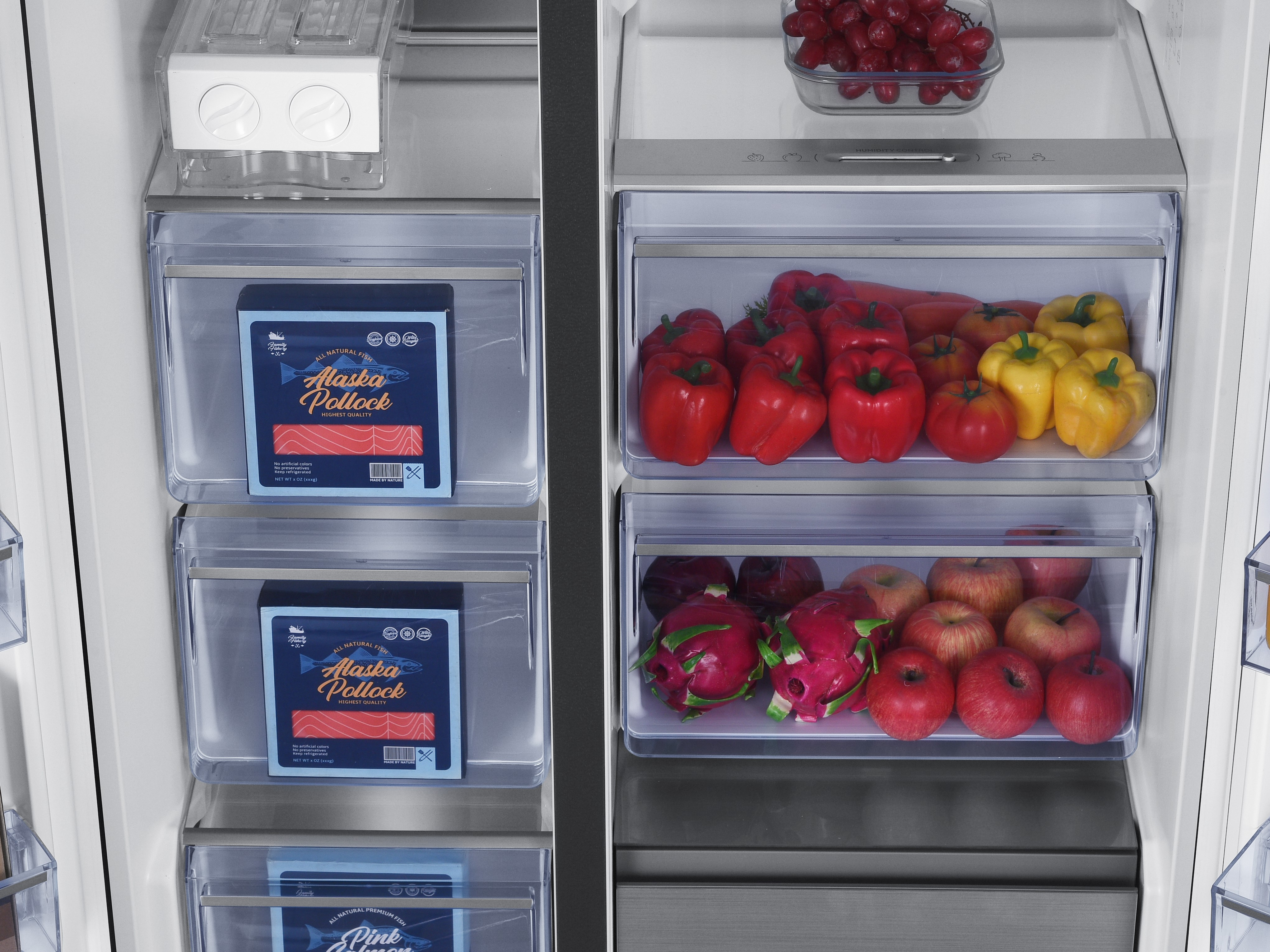 A two-door refrigerator filled with food. Alaska pollock on the left, peppers and fruit on the right.