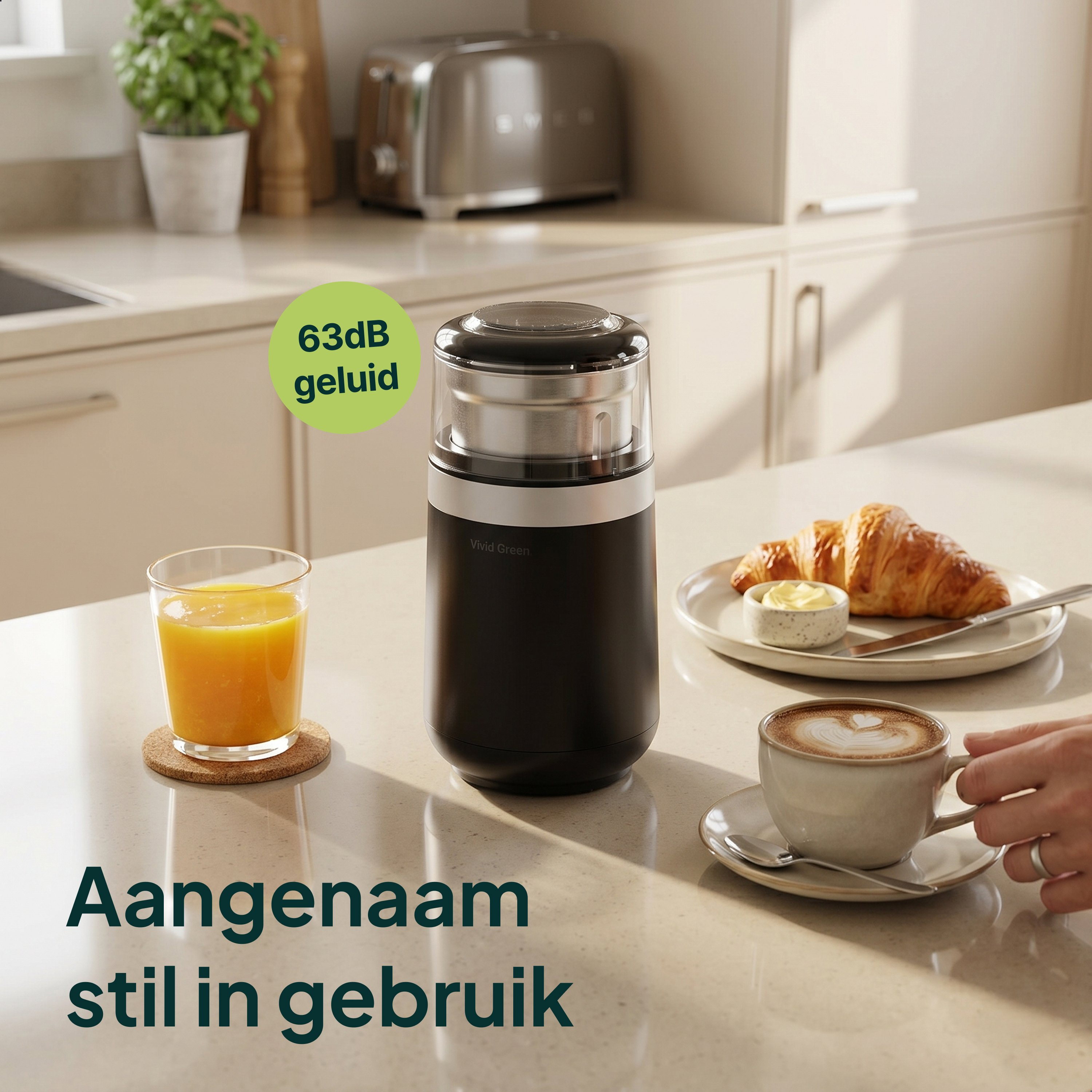 Coffee grinder with orange juice, croissant, and coffee on kitchen counter.