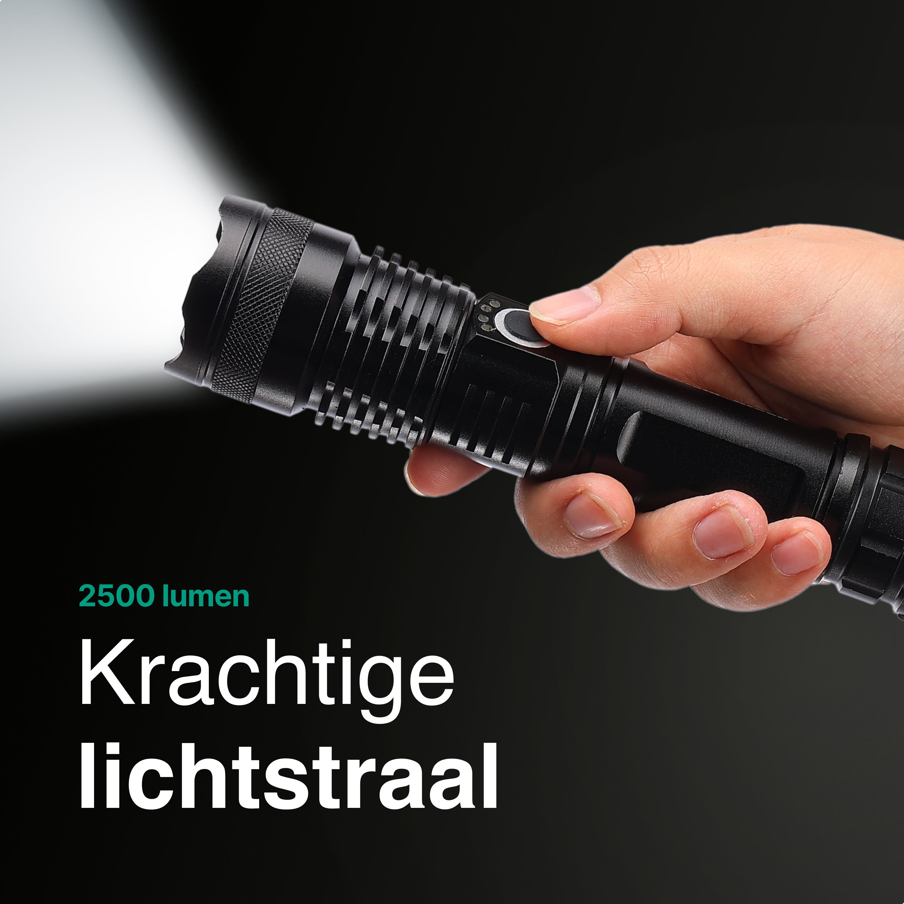 Hand holding black flashlight with bright light beam on dark background.