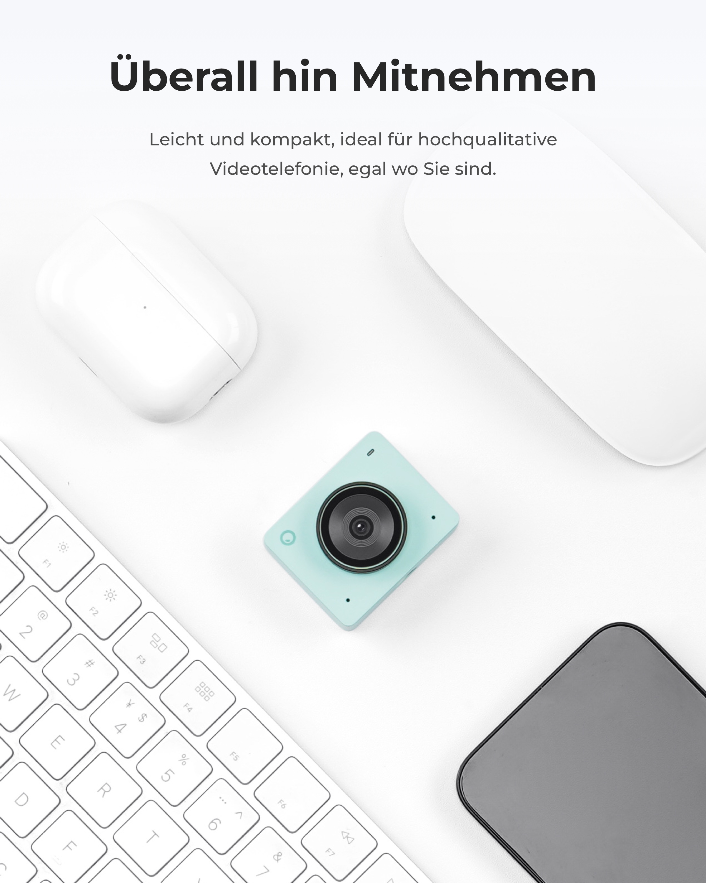Un gadget vert menthe avec objectif, clavier, souris, téléphone et écouteurs.