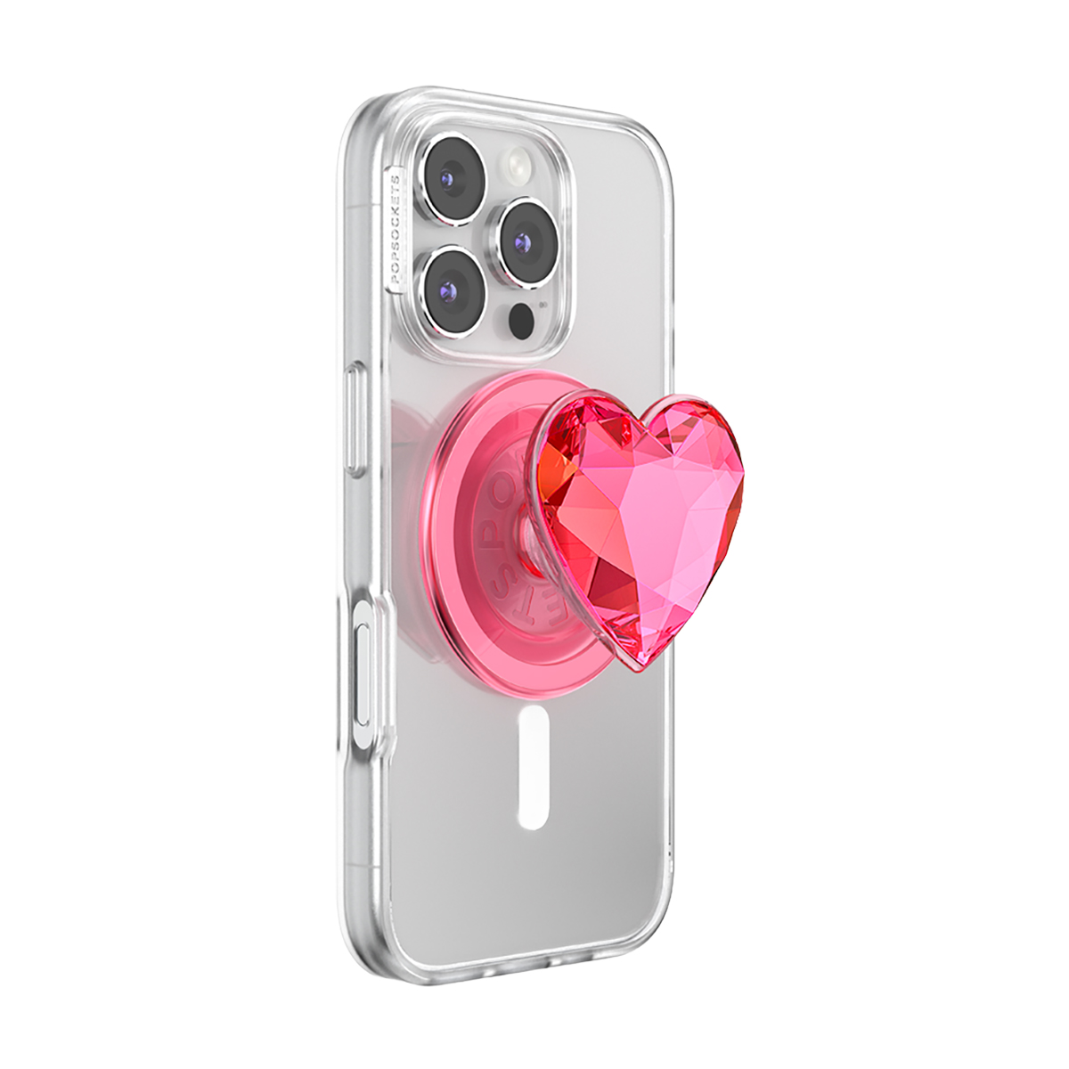 Un PopSocket rosa en forma de corazón adorna una funda transparente de iPhone.