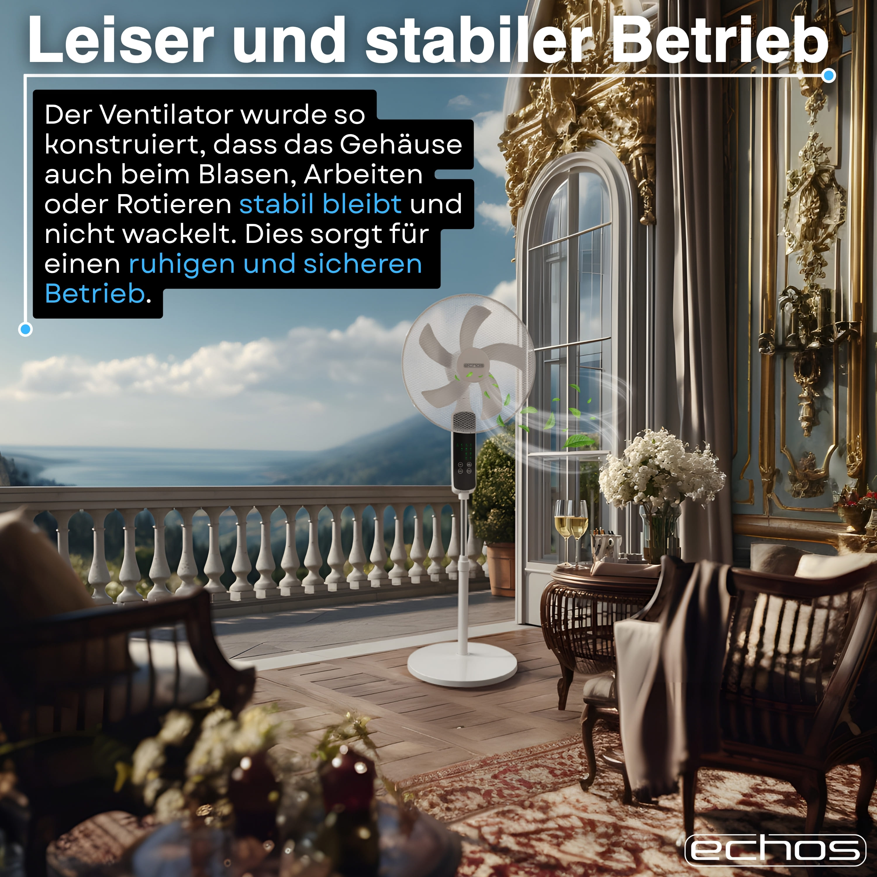 Ein weißer Ventilator steht auf einer Terrasse mit Blick auf das Meer. Dekorative Möbel sind im Vordergrund.
