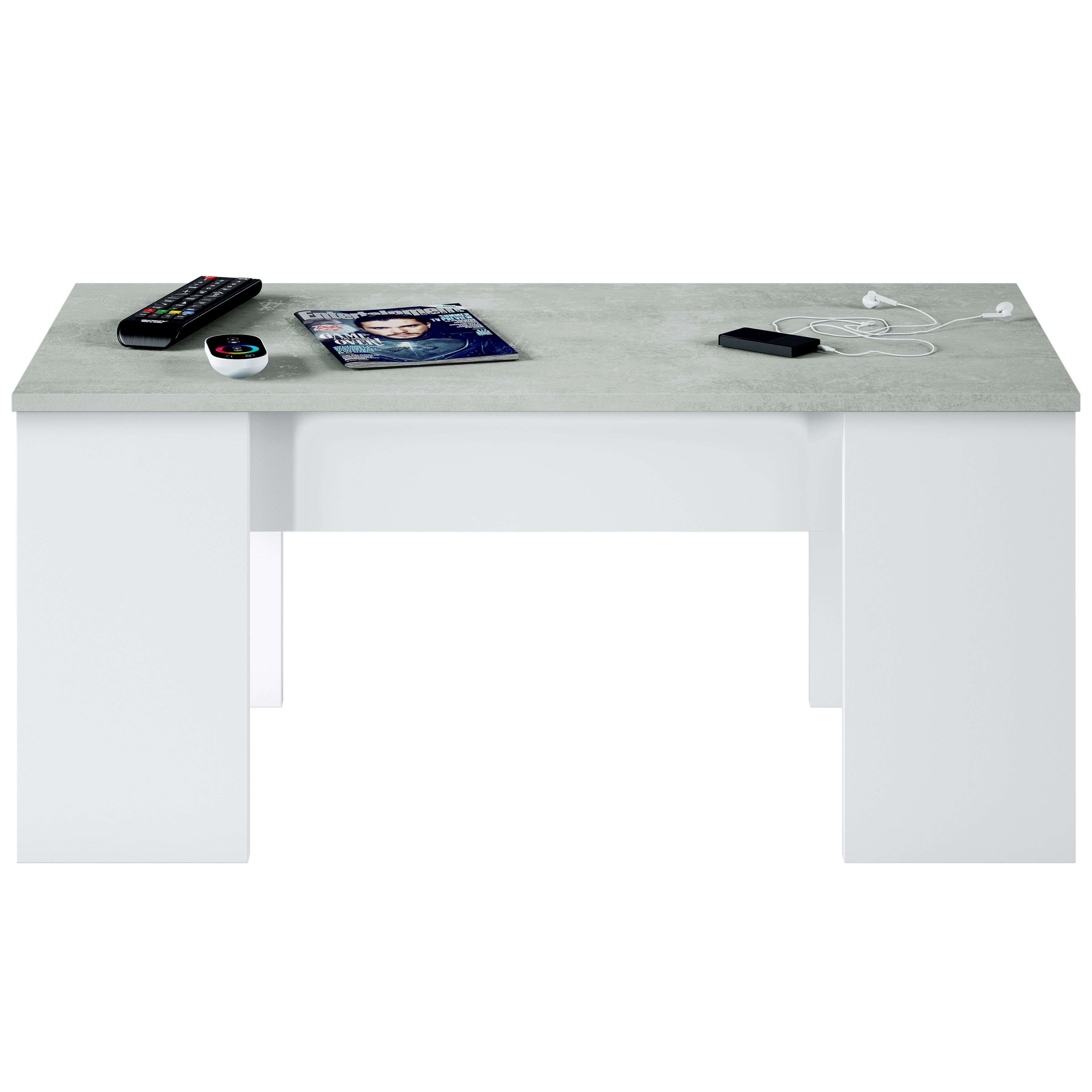 Una mesa de centro blanca con tapa efecto hormigón, con revista, mandos y auriculares encima.